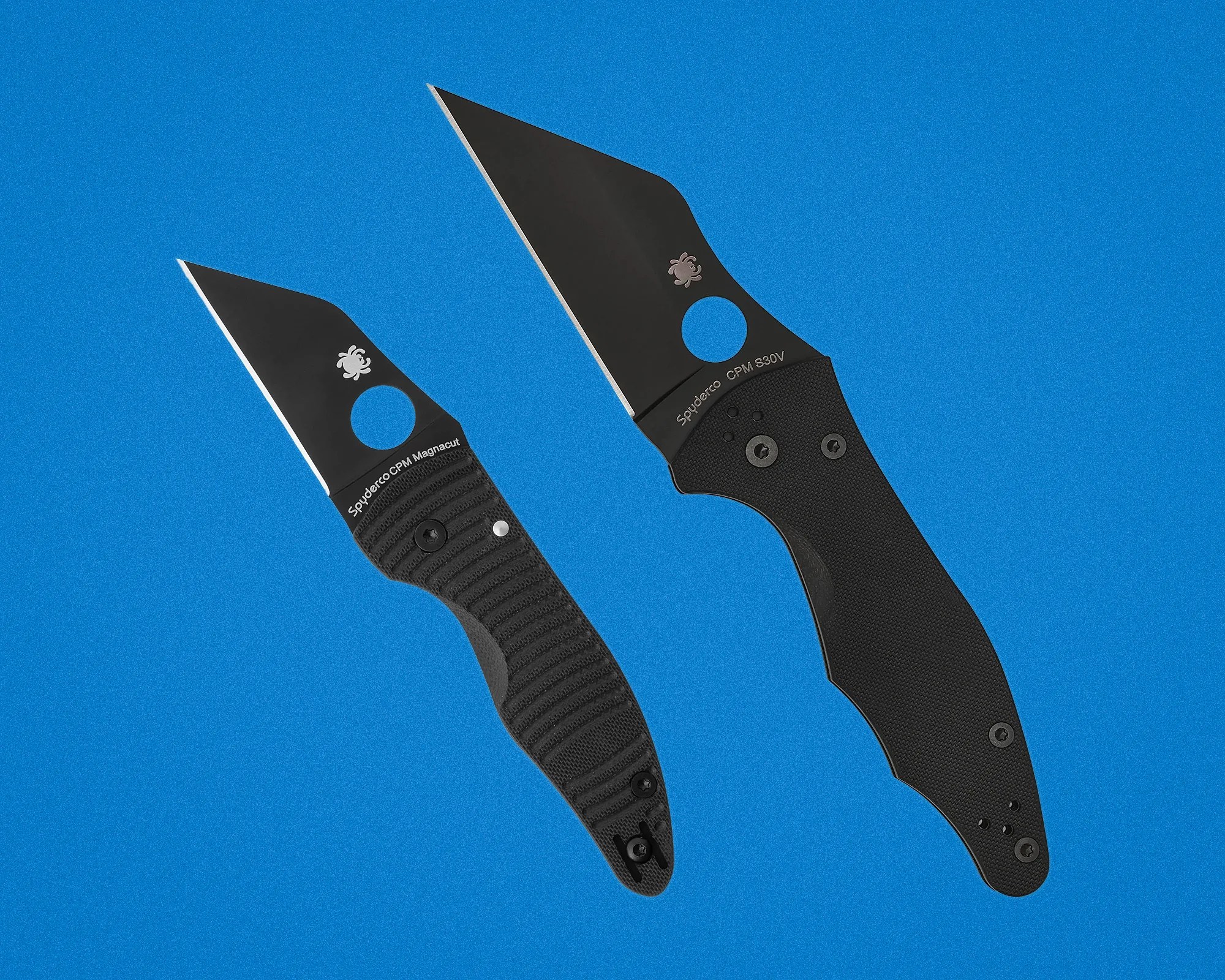 Two black Spyderco folding knives with textured handles and partially serrated blades on a blue background.