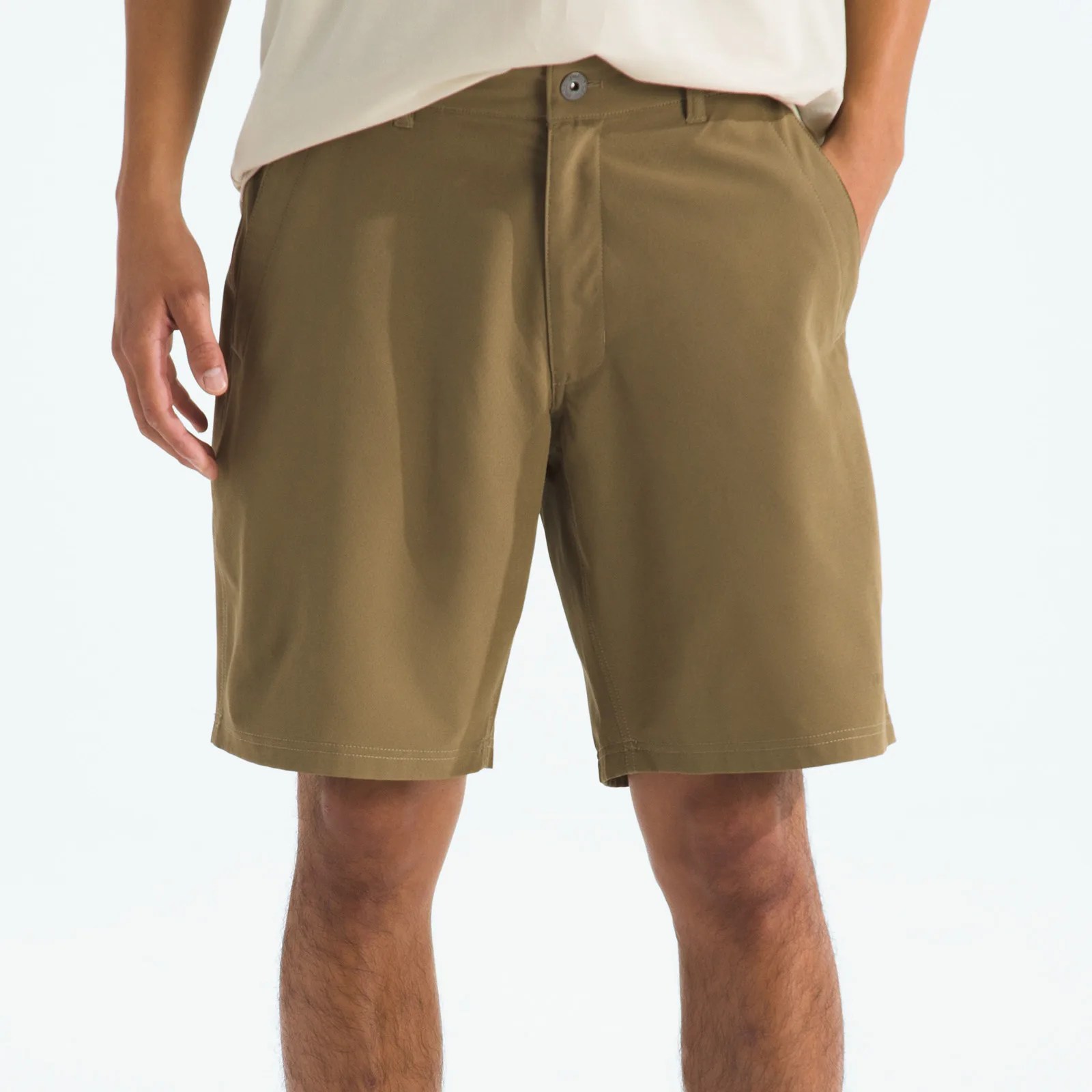 Khaki-colored casual shorts with front pockets worn by a person.