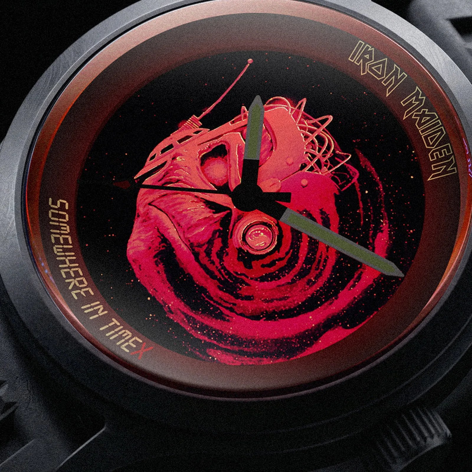 Close-up of a black watch face with red swirling design, "Iron Maiden" text, and "Somewhere in Time" on the bezel.