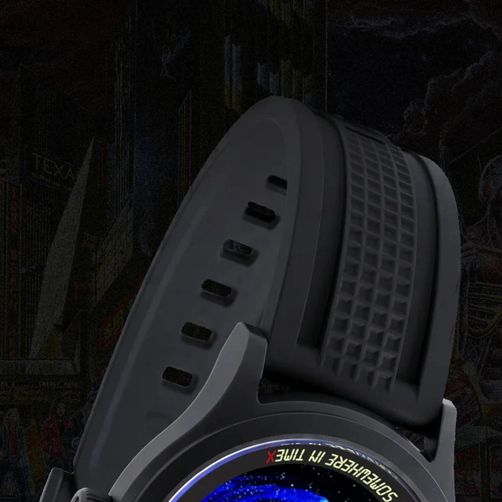Black smartwatch with a textured black silicone strap and a colorful galaxy-themed watch face.