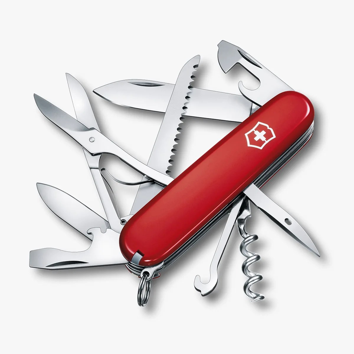 Red Swiss Army knife with multiple tools extended, including scissors, saw, corkscrew, and blades.