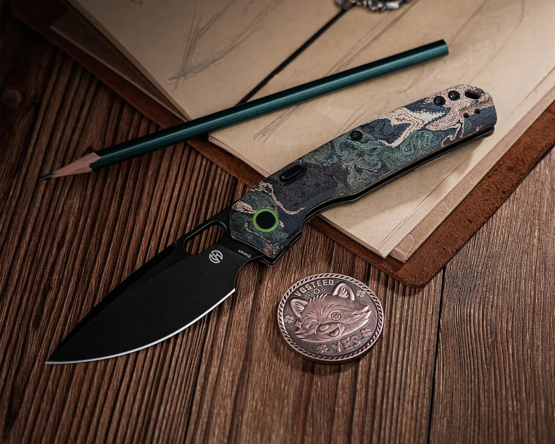 Black folding knife with a textured green and beige handle, green pencil, and round metal coin on a wooden surface.