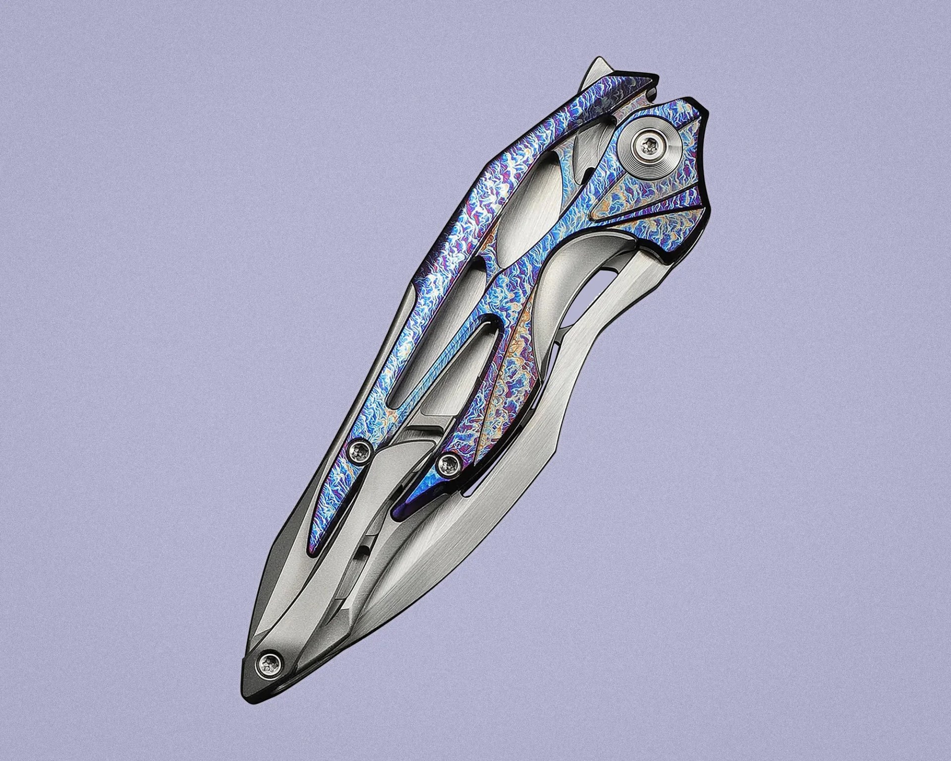 Futuristic titanium folding knife with intricate blue and purple anodized patterns on the handle.
