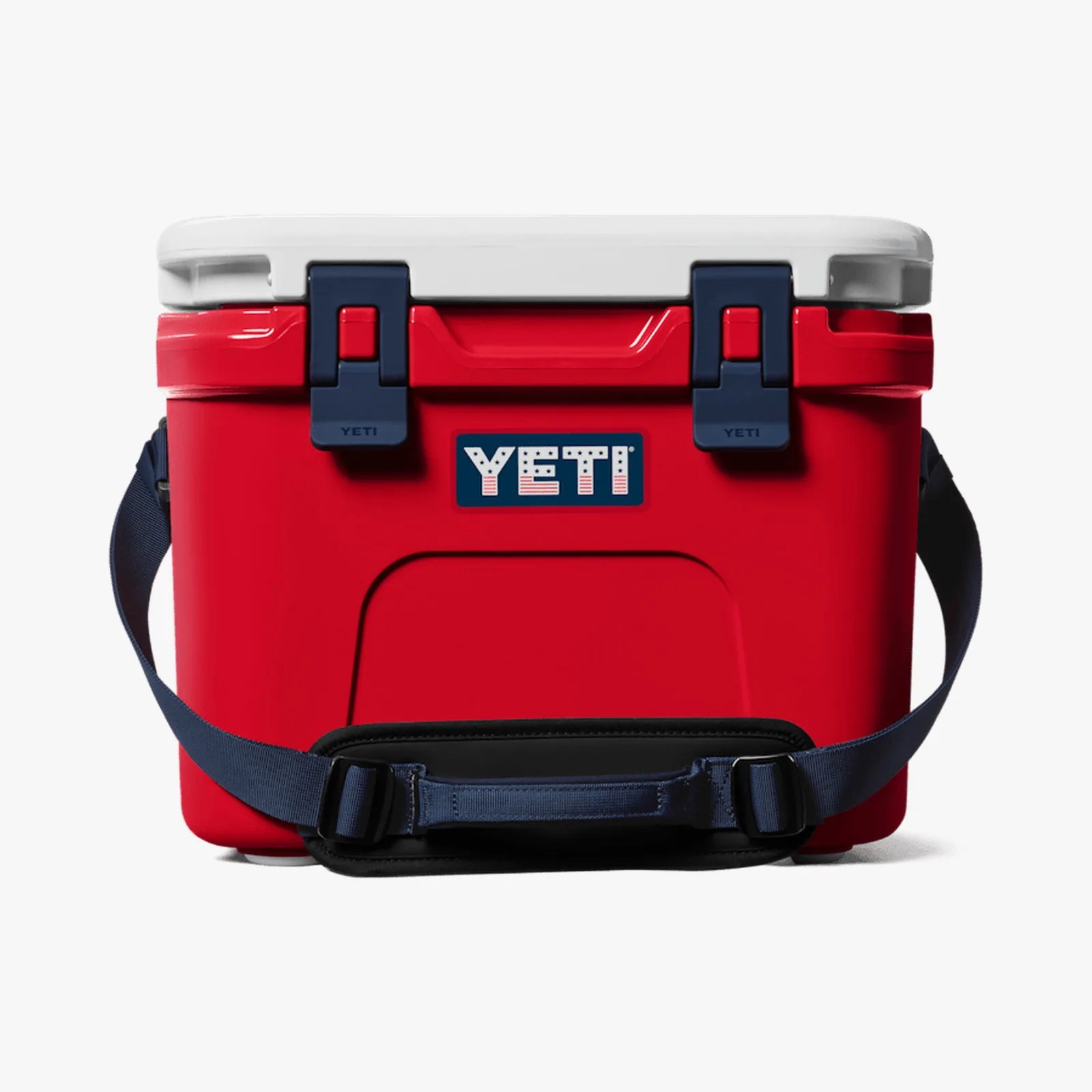 Red YETI cooler with white lid, navy blue latches, and adjustable navy shoulder strap.