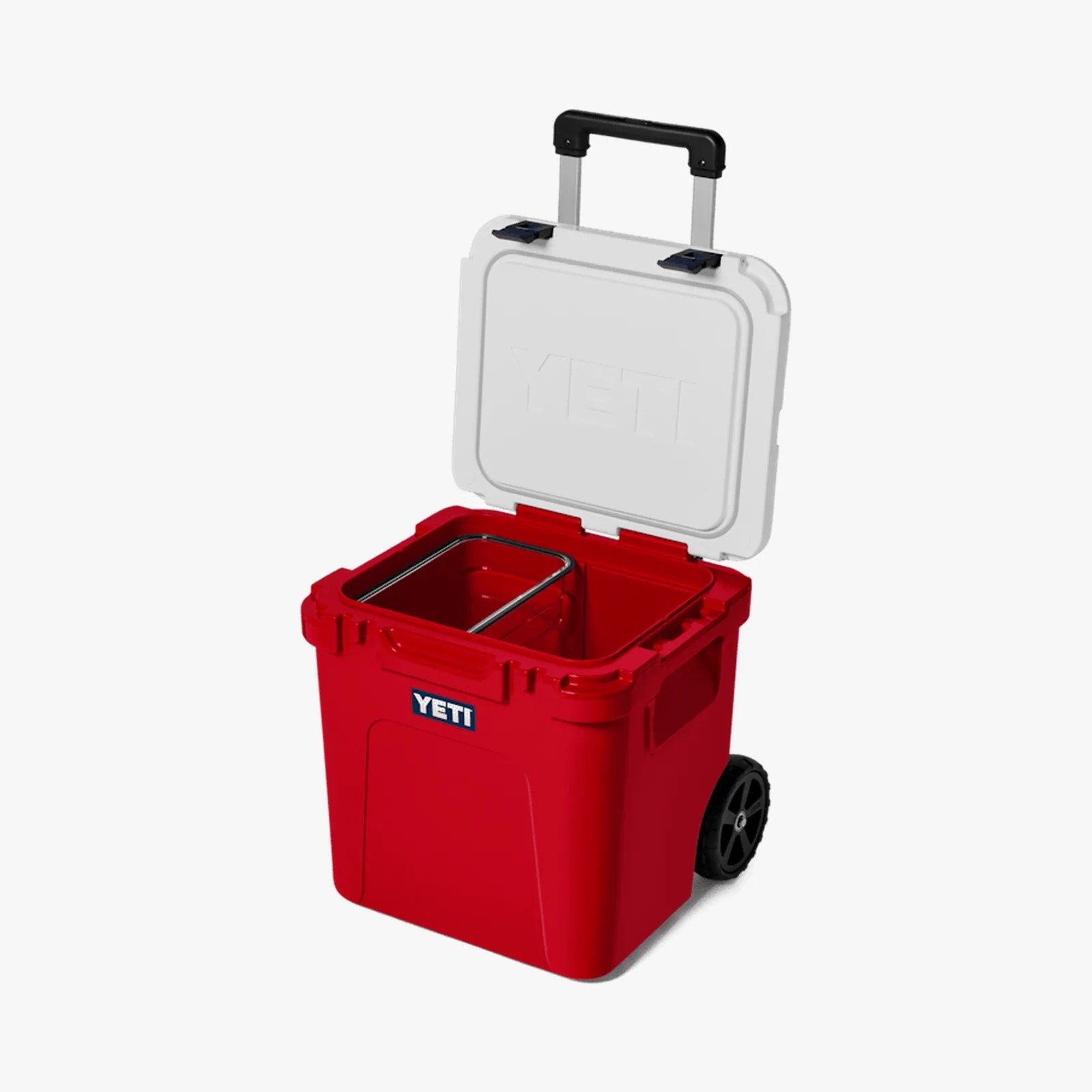 Red YETI wheeled cooler with white lid open and a metal divider inside.