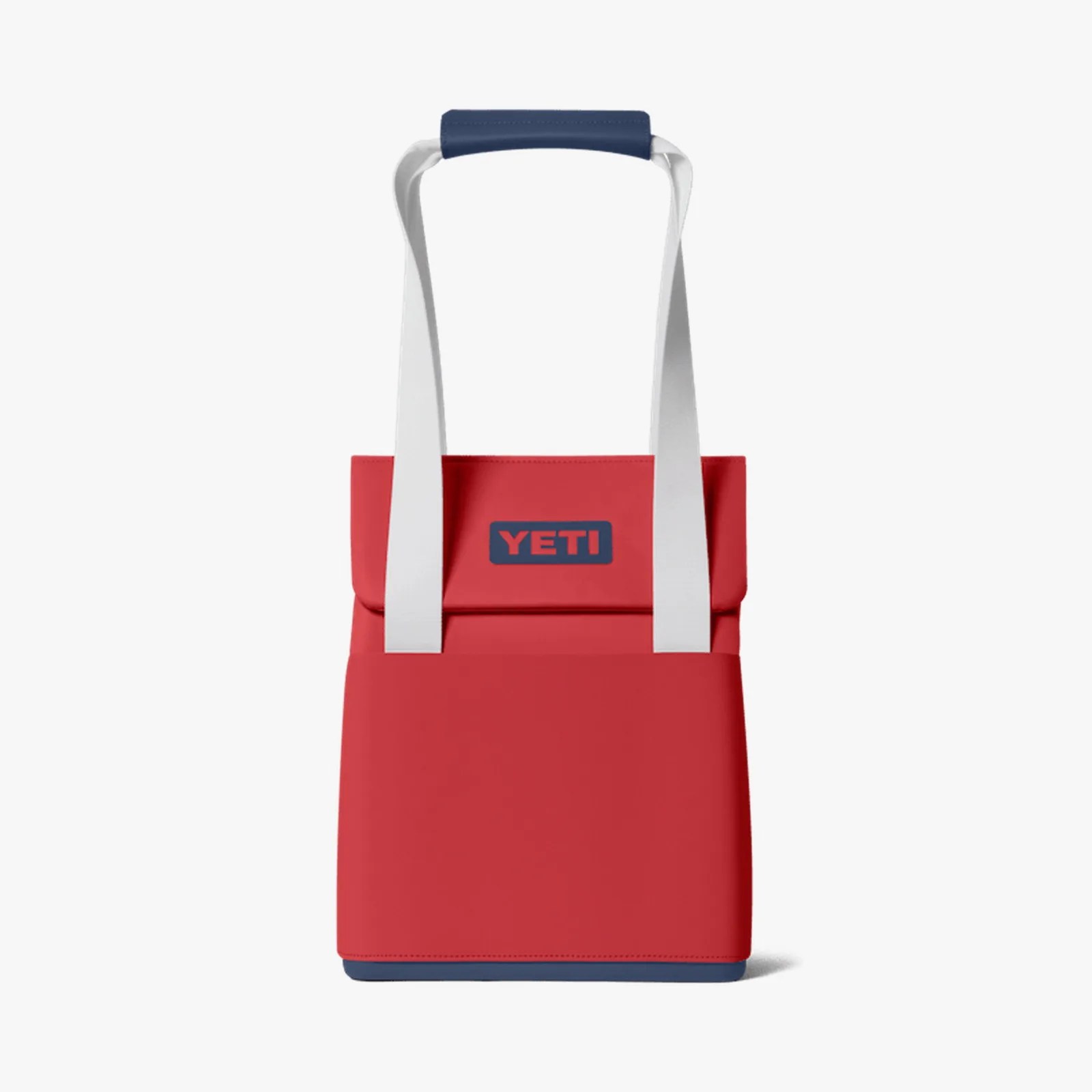 Red YETI cooler bag with white straps and navy blue handle and base.