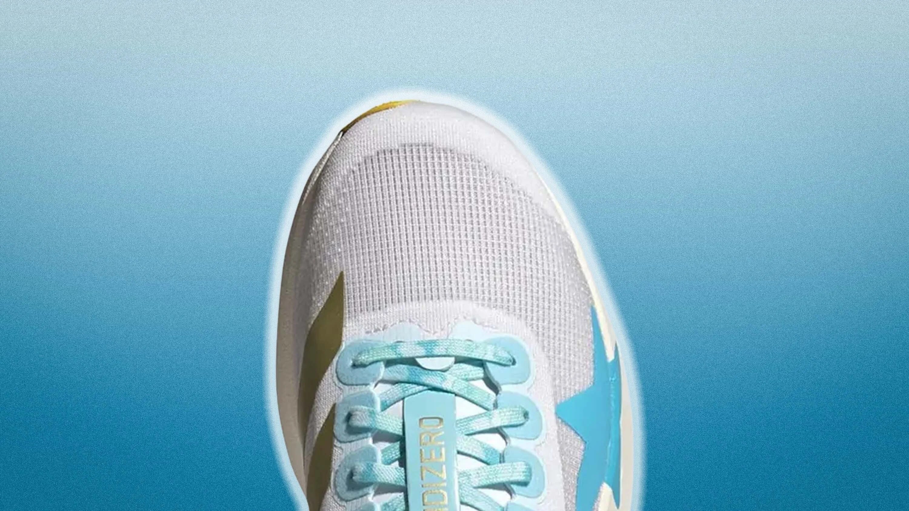 White and light blue athletic shoe with mesh upper and light blue laces on a blue gradient background.