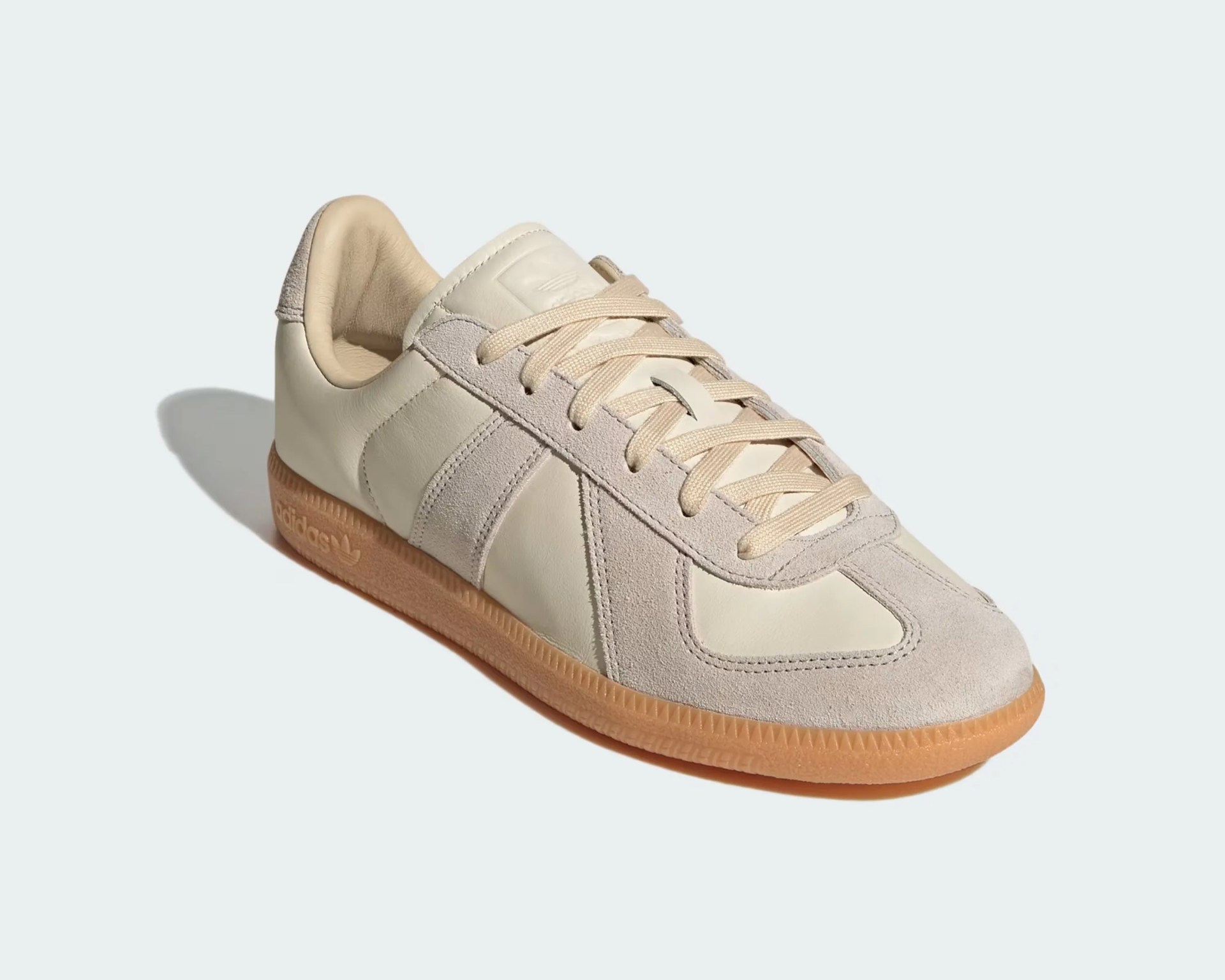 Beige Adidas sneaker with suede overlays and gum sole on a light background.