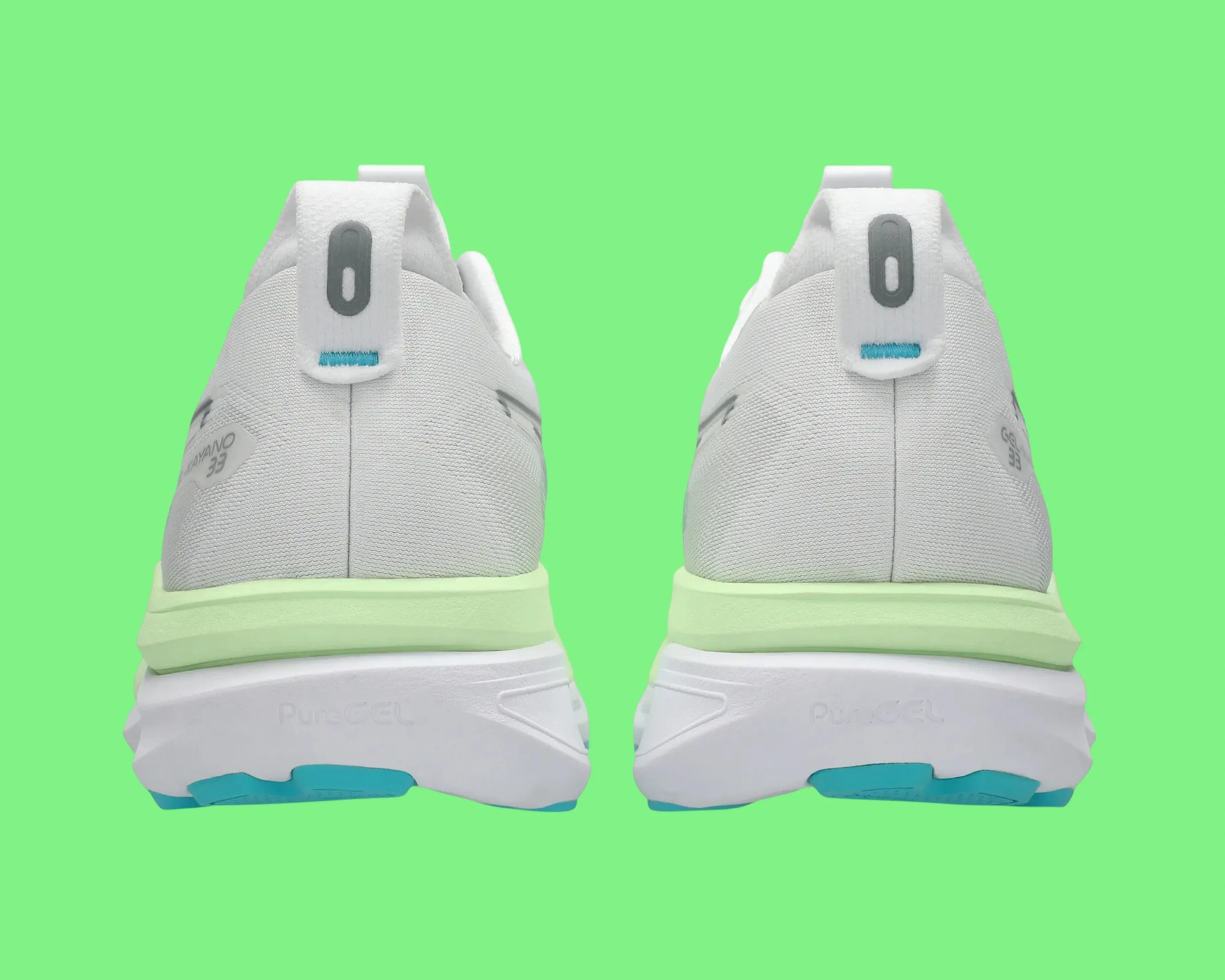 Pair of white athletic shoes with light green midsoles and blue accents, viewed from the back on a green background.