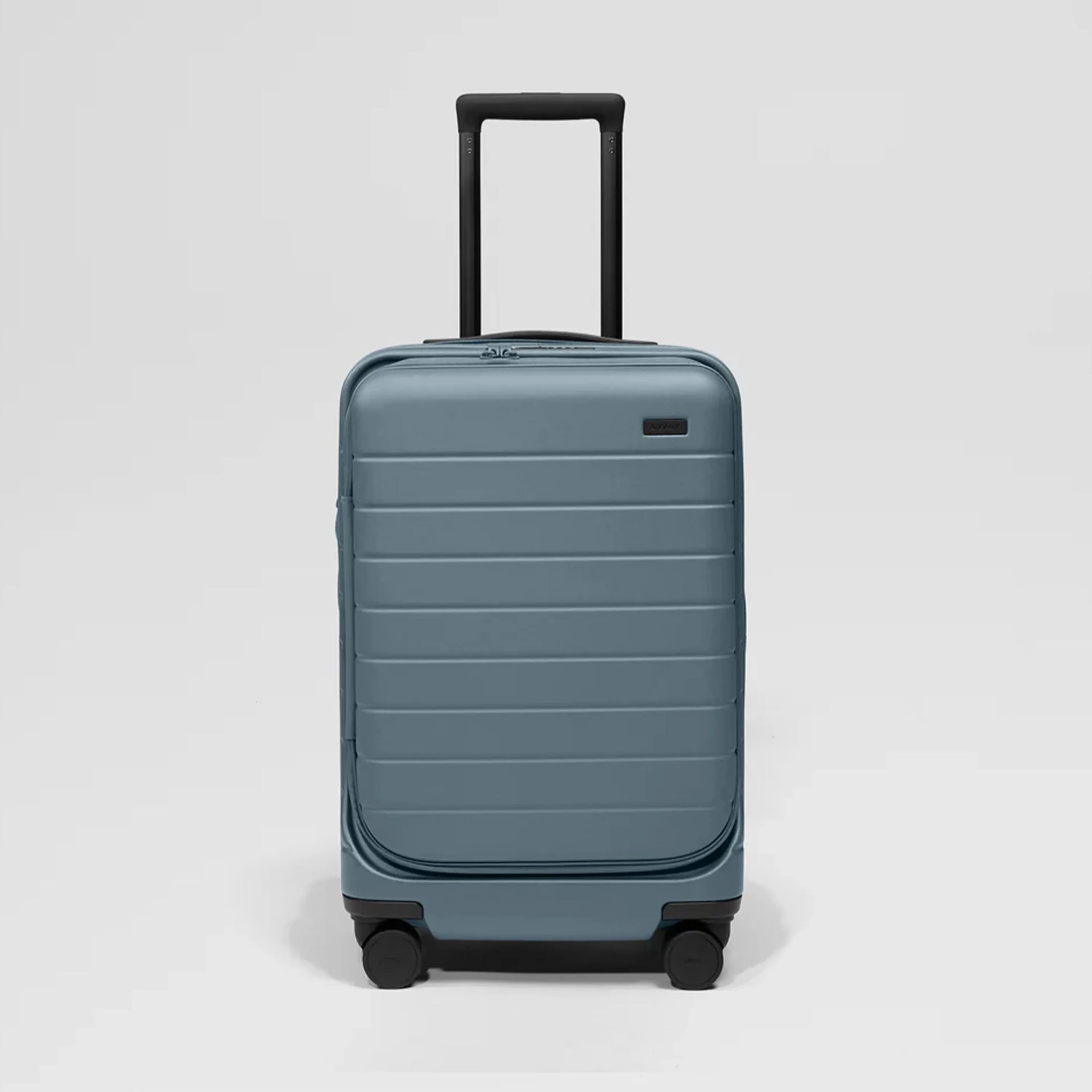 Blue hard-shell suitcase with black telescopic handle and four black wheels on a white background.