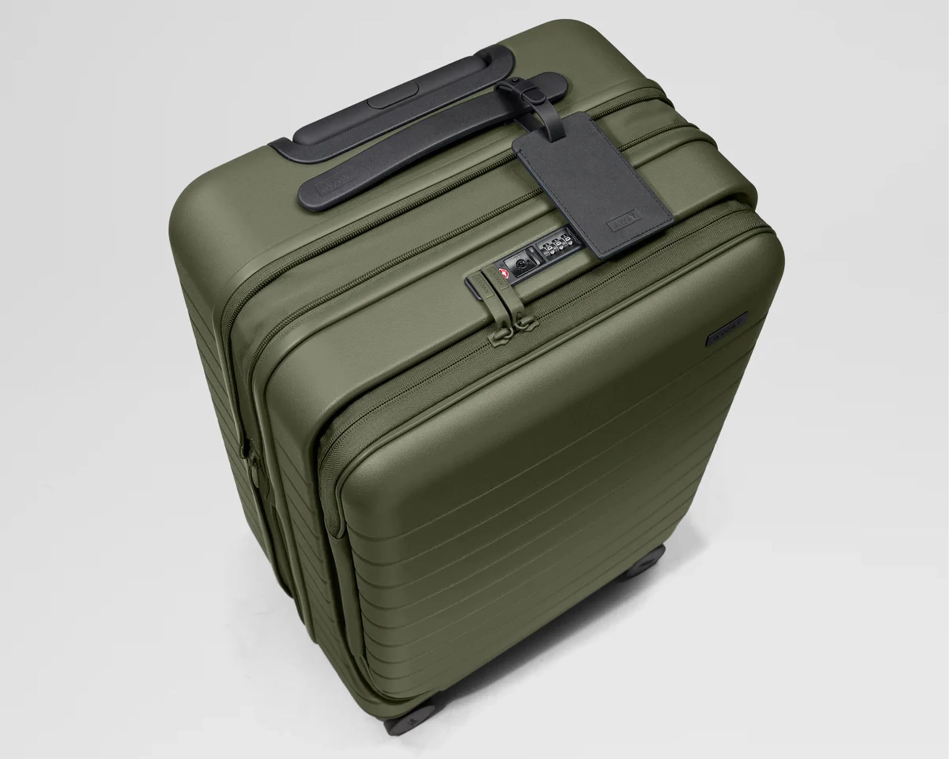 Olive-green hard-shell suitcase with black handle, zipper, combination lock, and attached black luggage tag.