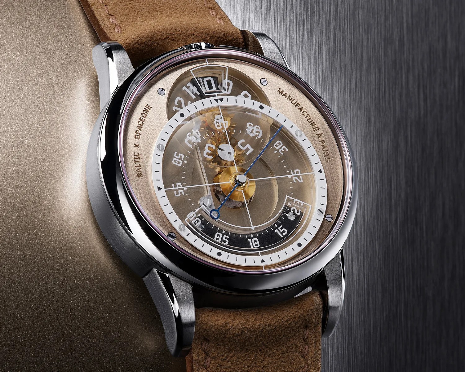 Close-up of a Baltic x Spaceone wristwatch with a transparent dial, brass-colored inner ring, and brown leather strap.