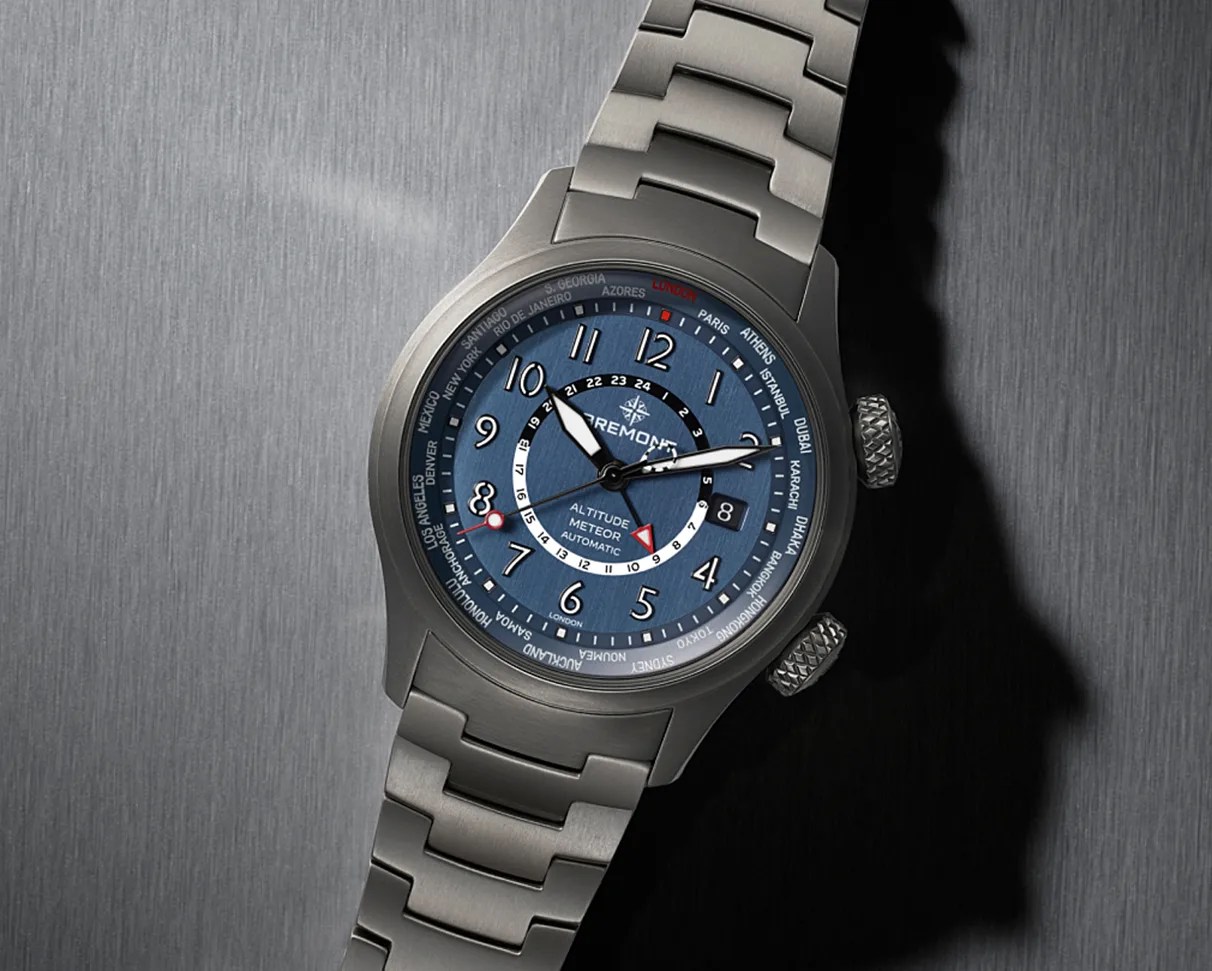 Stainless steel Bremont Altitude Meteor automatic watch with blue dial and world time cities on bezel.