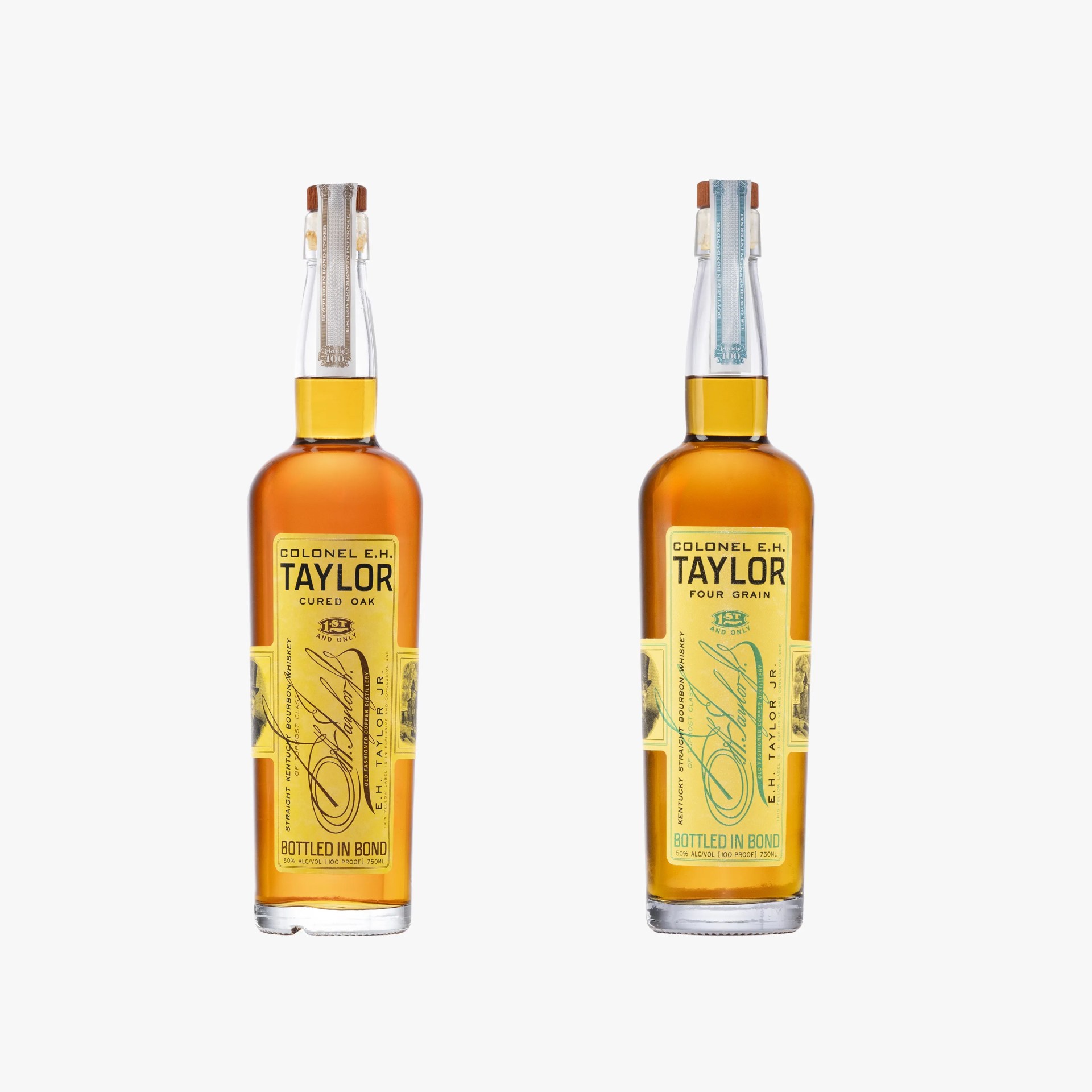 Two Colonel E.H. Taylor bourbon whiskey bottles with yellow labels, one labeled "Cured Oak" and the other "Four Grain.