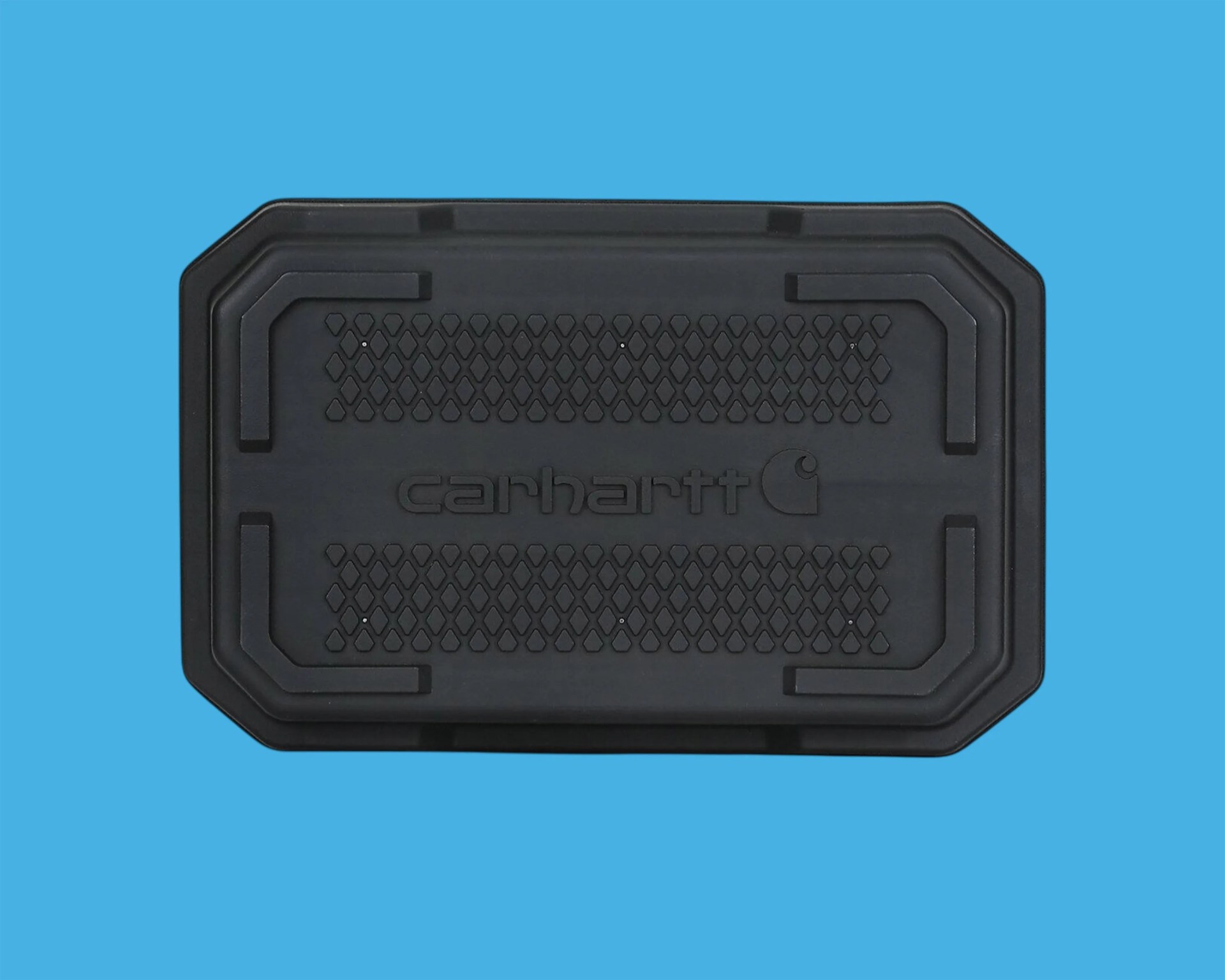 Black Carhartt rubber floor mat with textured diamond pattern on blue background.