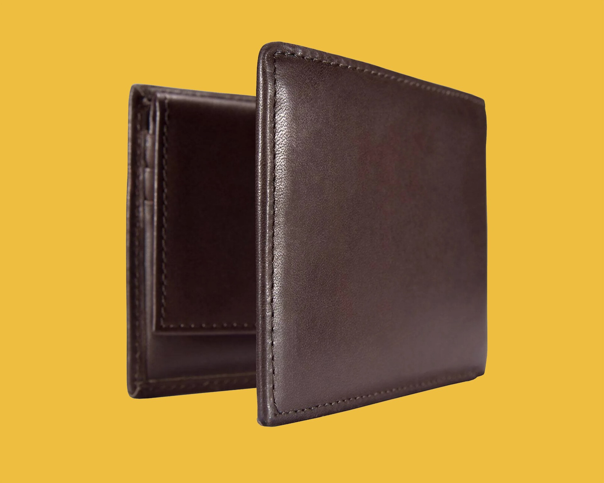 Brown leather bifold wallet with visible stitching on a yellow background.