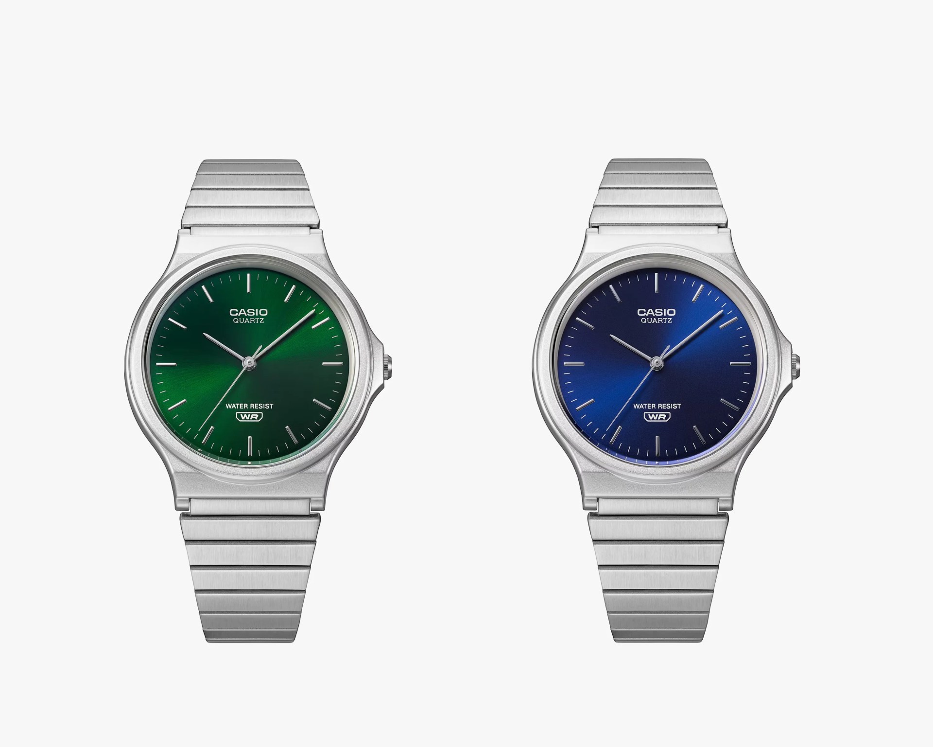 Two Casio quartz watches with silver metal bands, one with a green dial and the other with a blue dial.