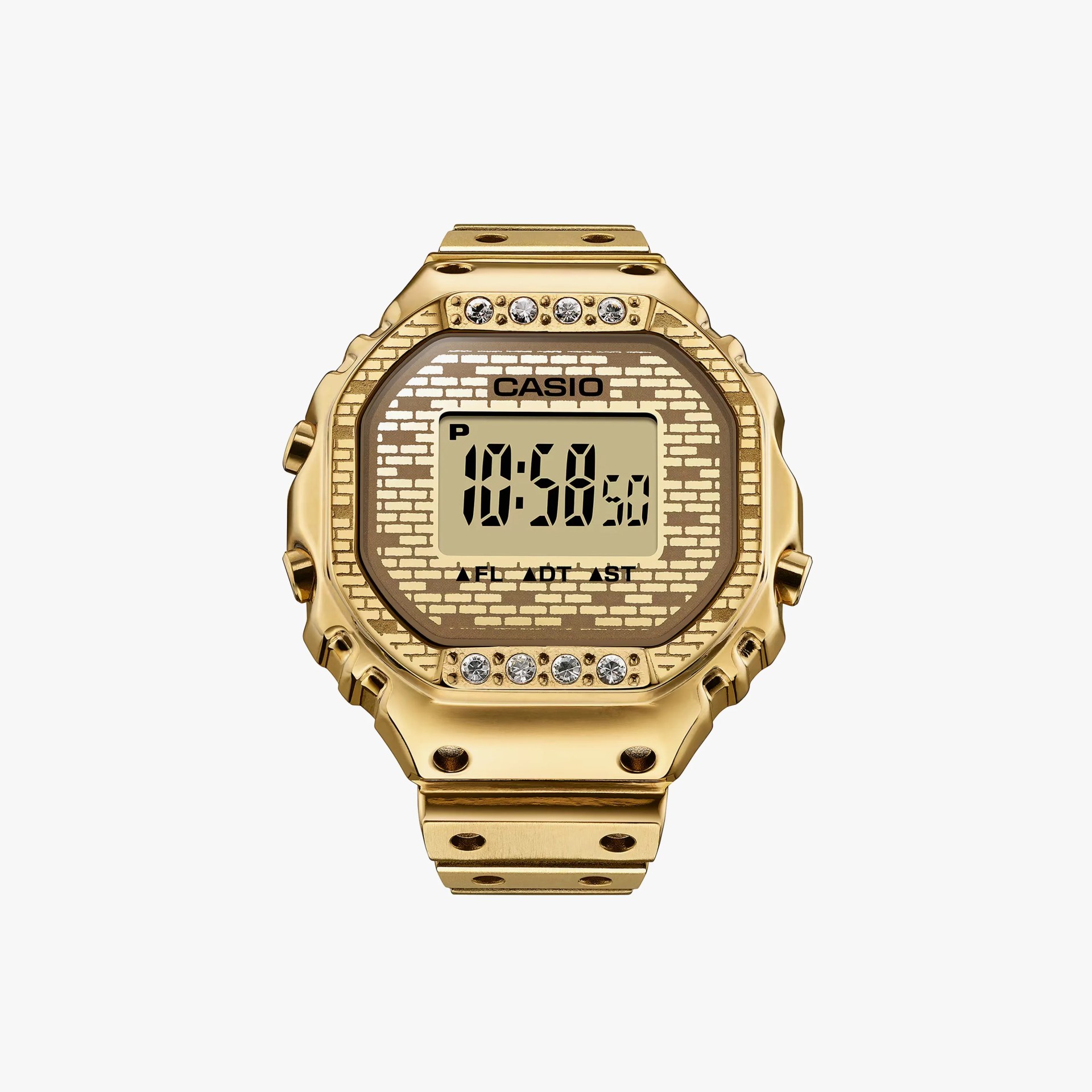 Gold Casio digital watch with a brick-patterned face and four crystals above and below the display.