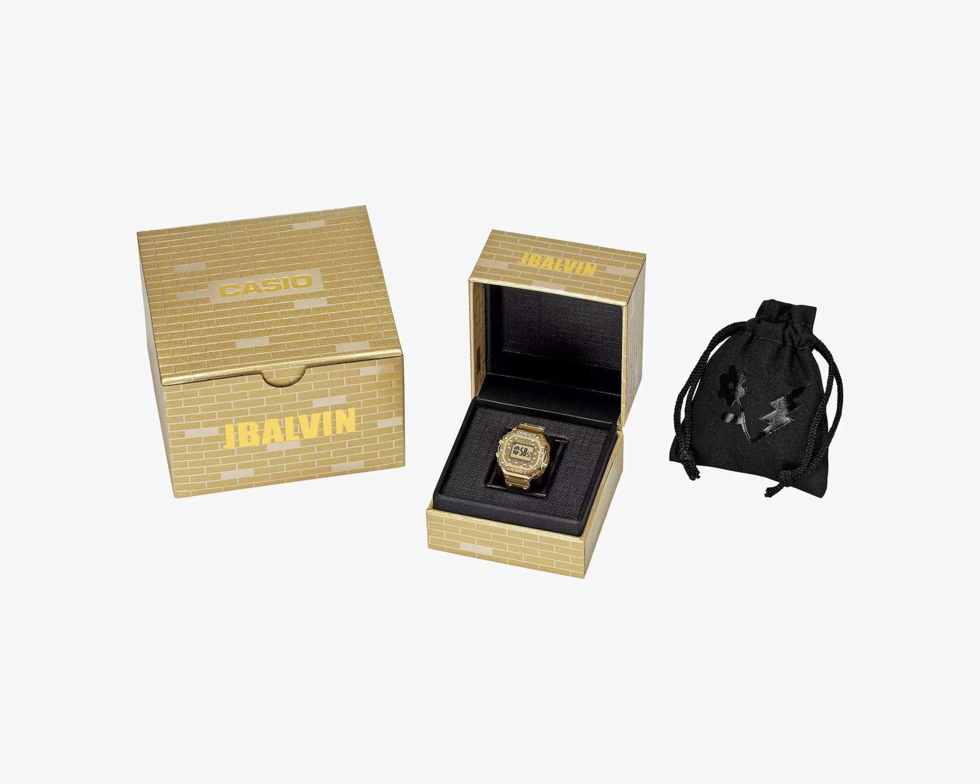 Gold Casio digital watch in a gold brick-patterned box with a black drawstring pouch featuring a flower and lightning bolt design.
