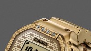 Close-up of a gold Casio digital watch bezel with four embedded crystals and a brick-patterned face.