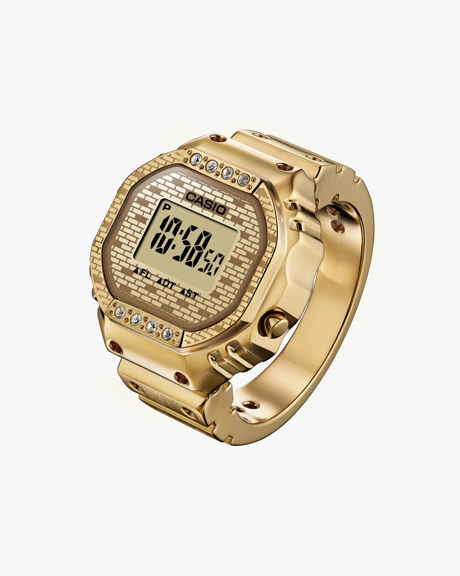 Gold-tone Casio digital watch with a brick-patterned face and crystal accents on the bezel.