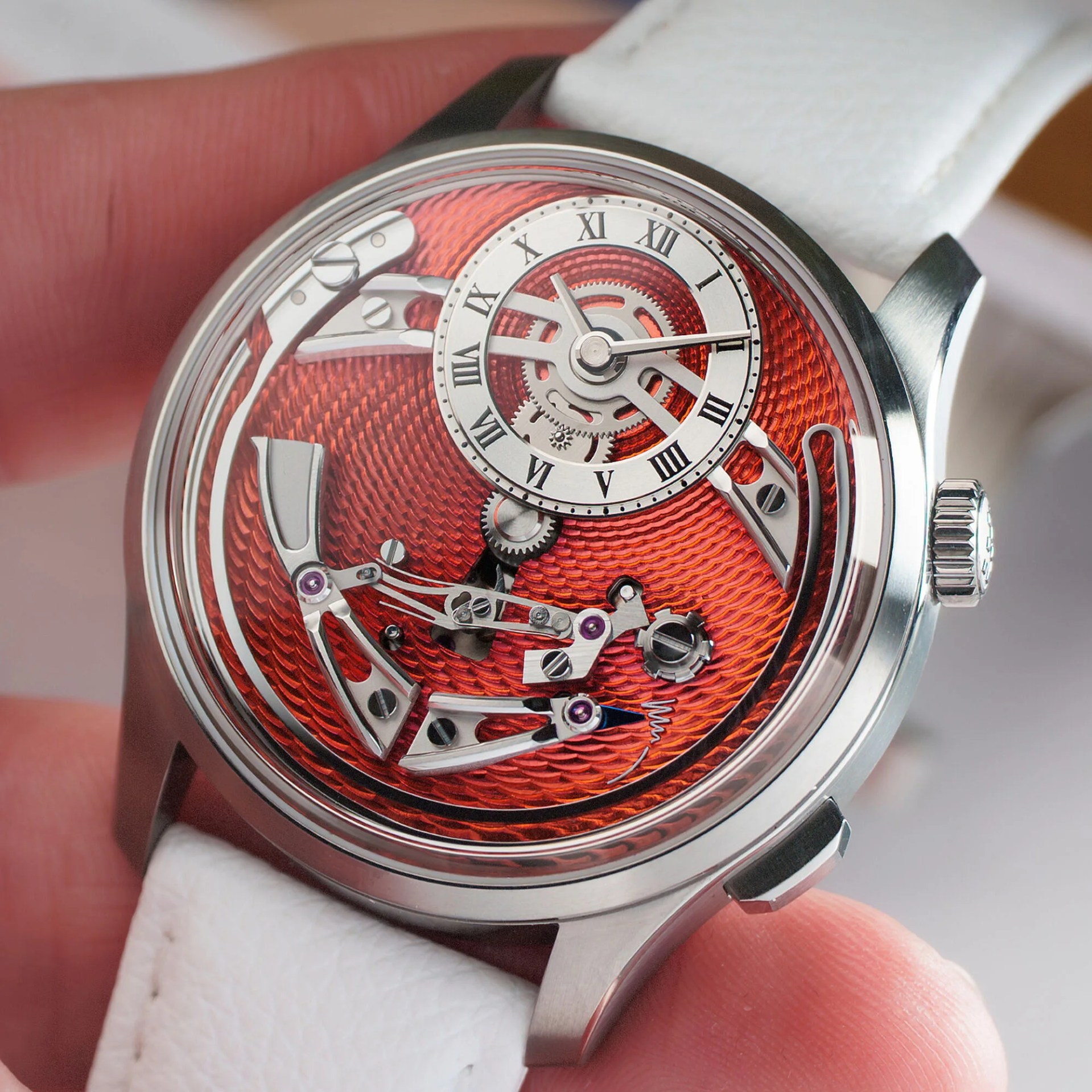 Close-up of a mechanical wristwatch with a textured red dial, silver gears, Roman numeral hour markers, and a white leather strap.