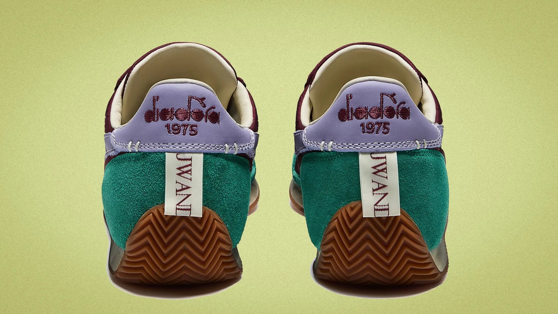Pair of sneakers with green suede heels, purple leather collars, and brown rubber soles on a light green background.