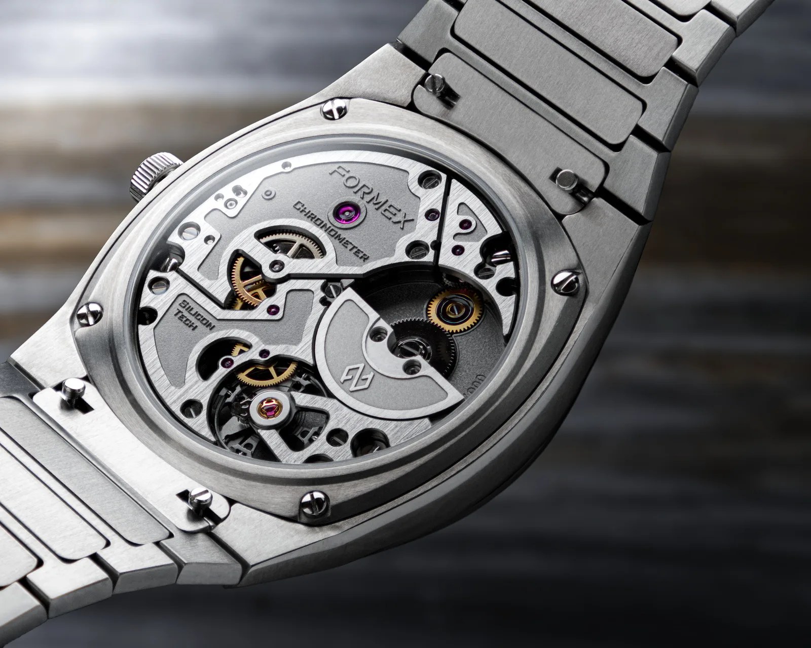 Close-up of a silver Formex chronometer watch movement with visible gears and "Silicon Tech" engraving.