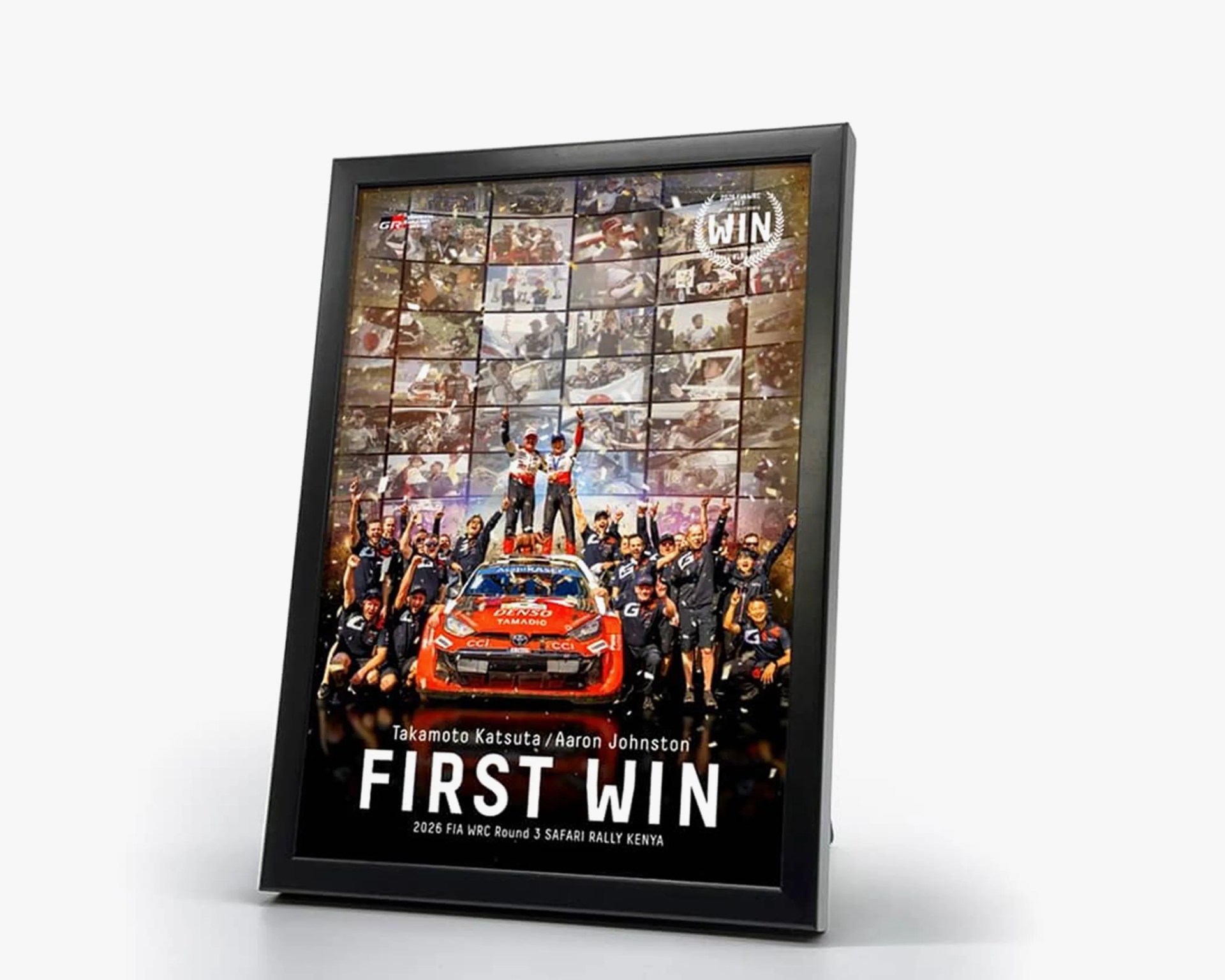 Framed poster showing a rally car team celebrating with "FIRST WIN" text and "2026 FIA WRC Round 3 Safari Rally Kenya" below.