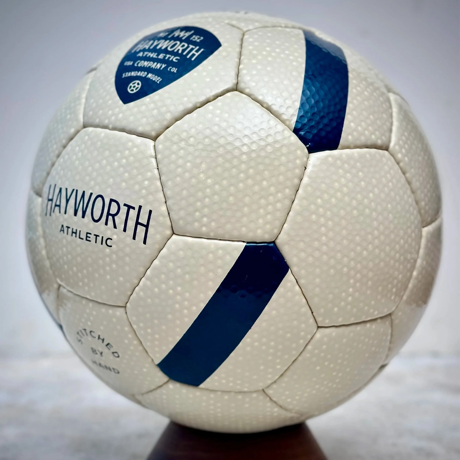 White textured soccer ball with blue diagonal stripes and "HAYWORTH ATHLETIC" text.