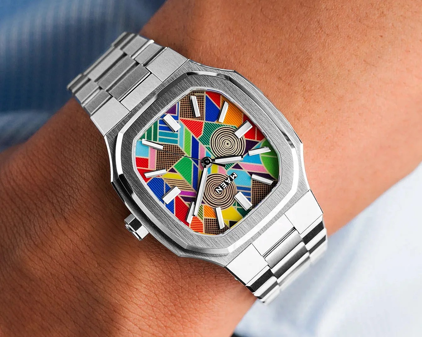 A vibrant steel watch on a man's wrist.