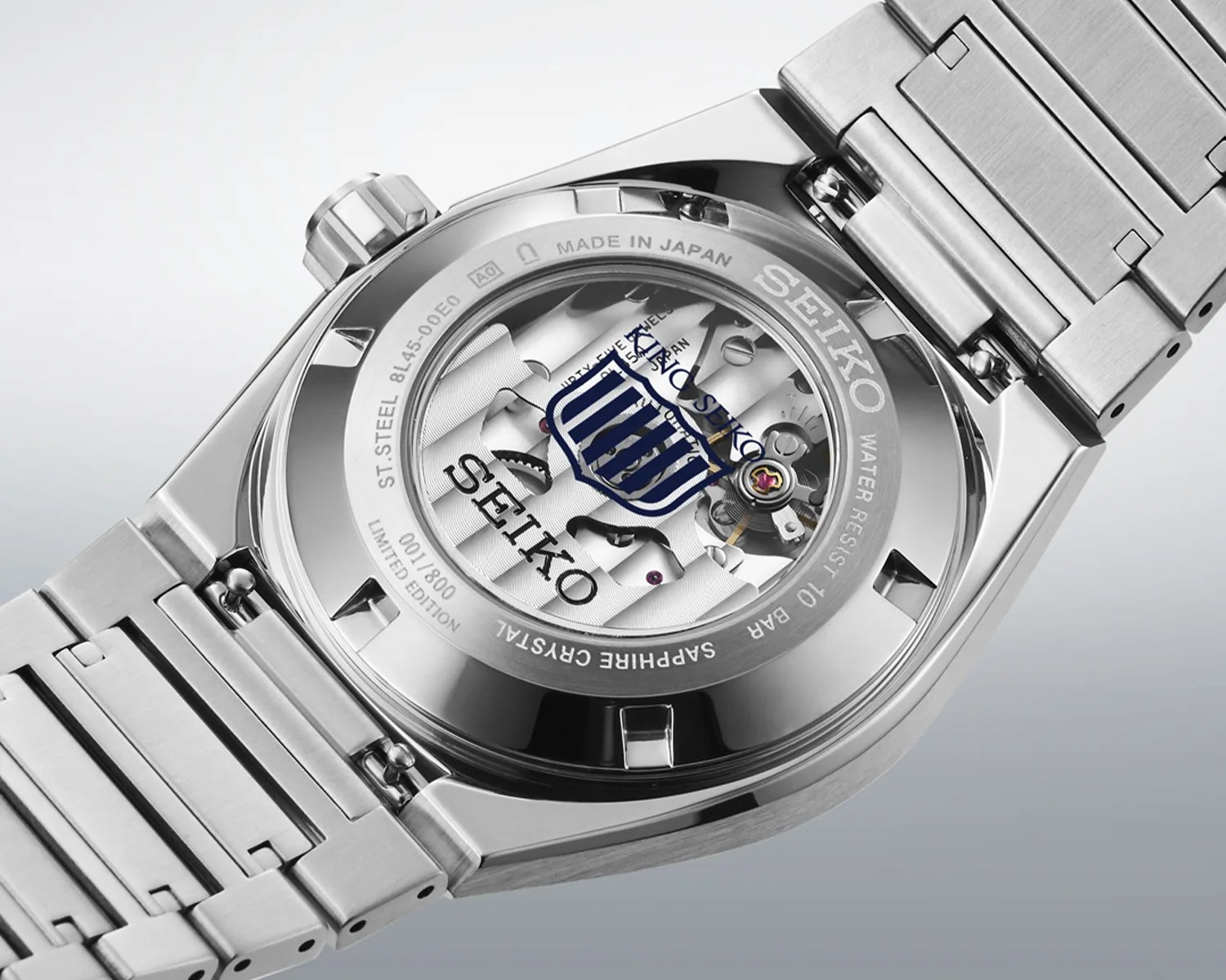 Back of a Seiko stainless steel watch with visible mechanical movement and crystal case back.