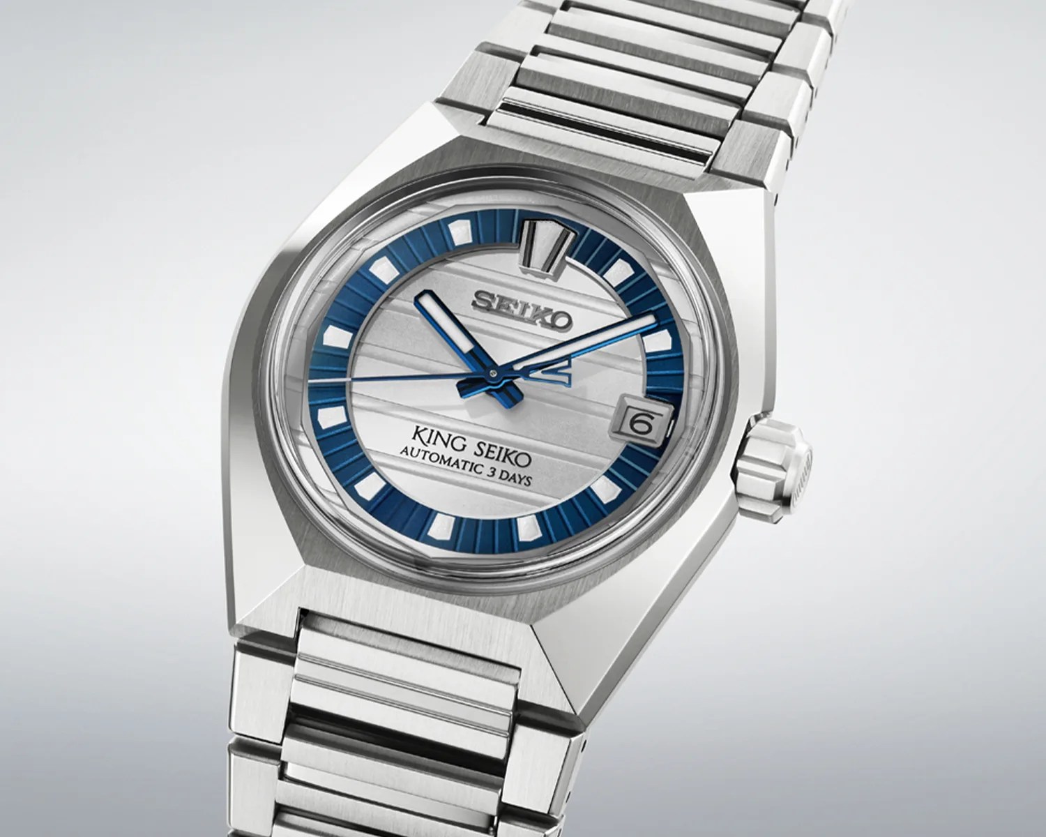 Silver stainless steel King Seiko wristwatch with blue and white dial and date display.