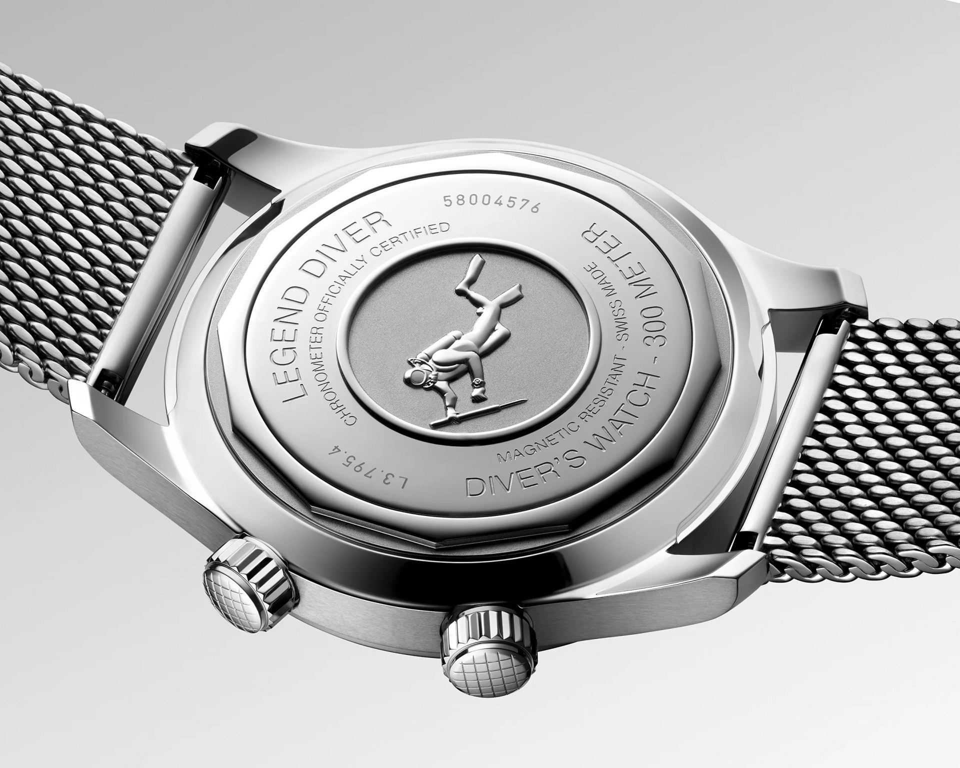 Close-up of the stainless steel case back of a Legend Diver watch with an engraved diver figure and mesh metal bracelet.