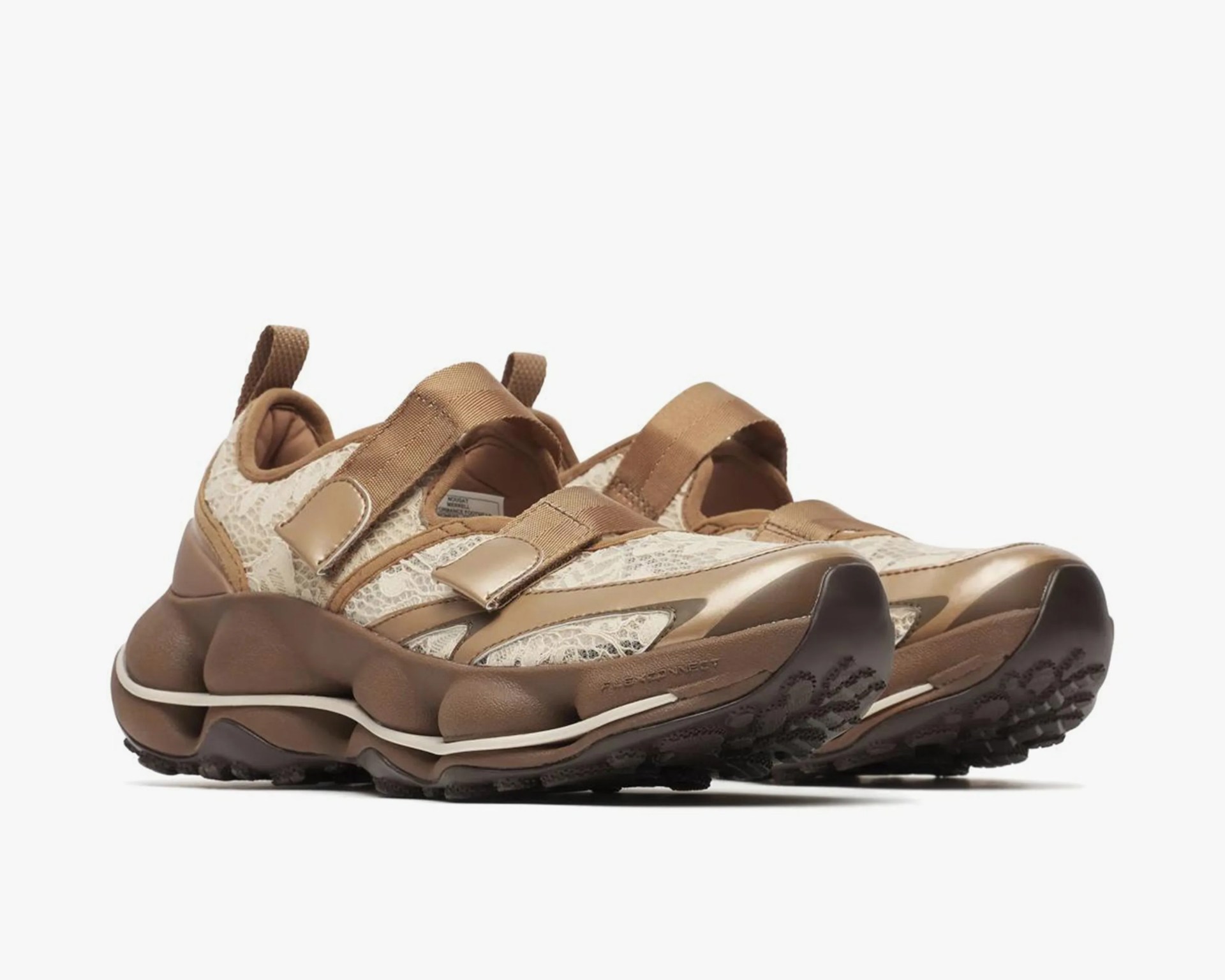 Chunky brown sneakers with beige lace fabric and thick textured soles.