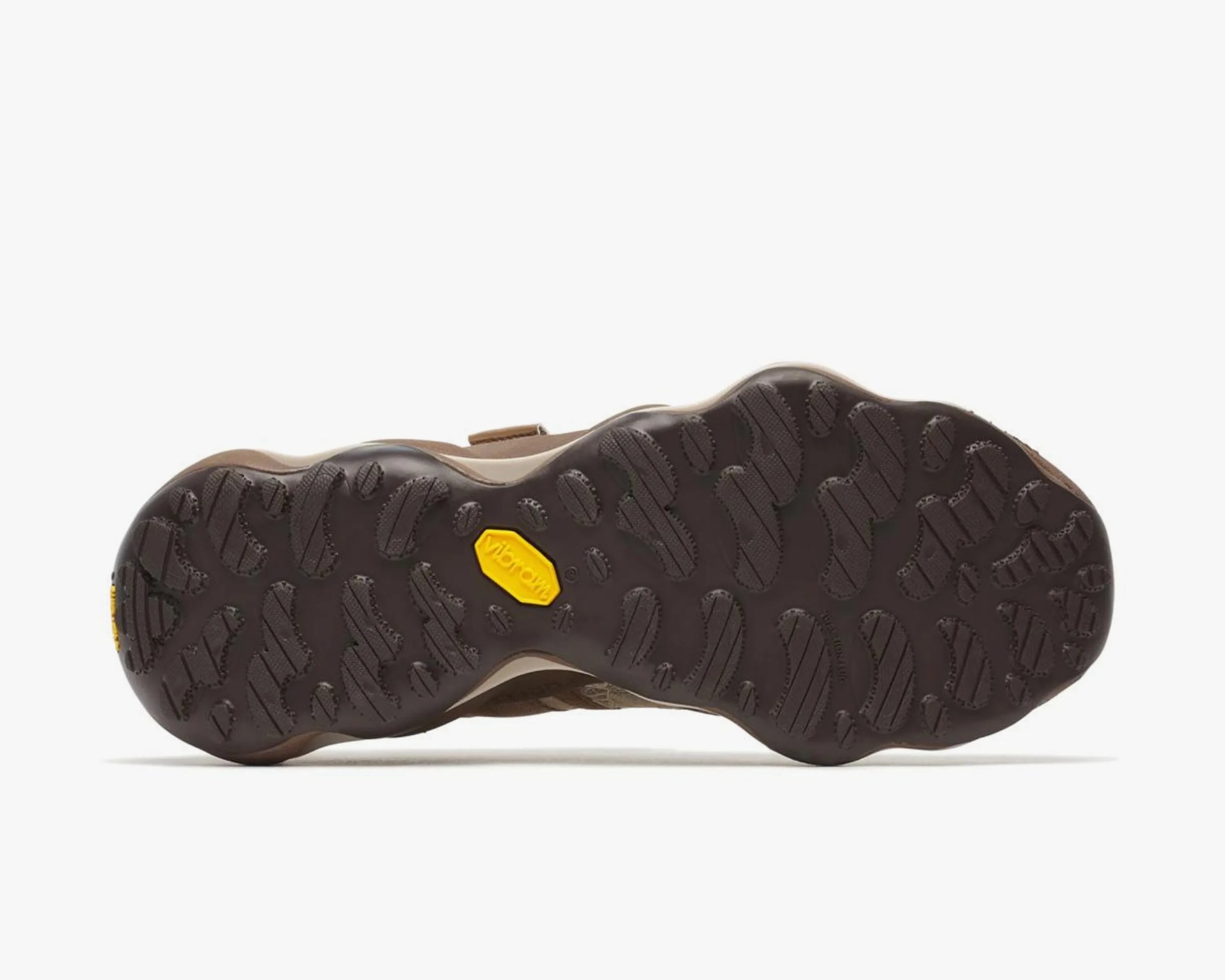 Dark brown Vibram rubber sole with textured tread pattern on a shoe.