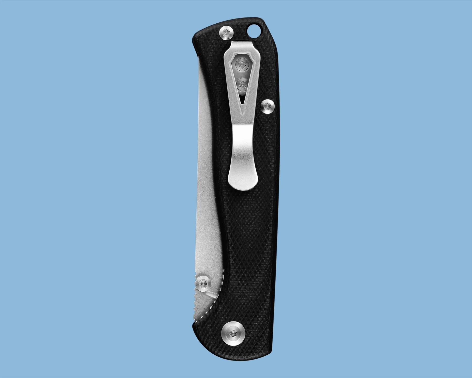 Black folding pocket knife with textured handle and silver metal clip on a blue background.