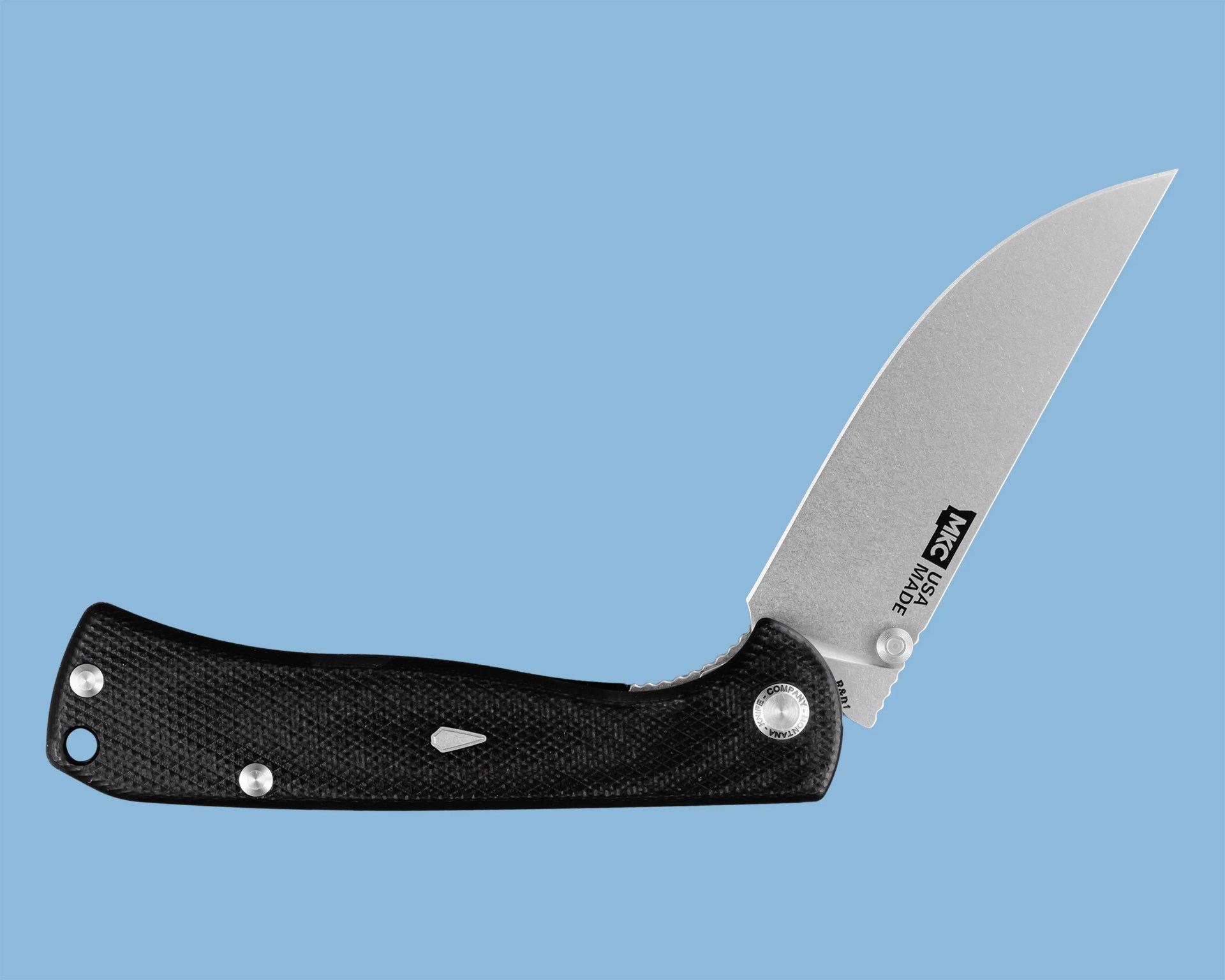 Folding knife with a black textured handle and a partially open stonewashed blade on a blue background.