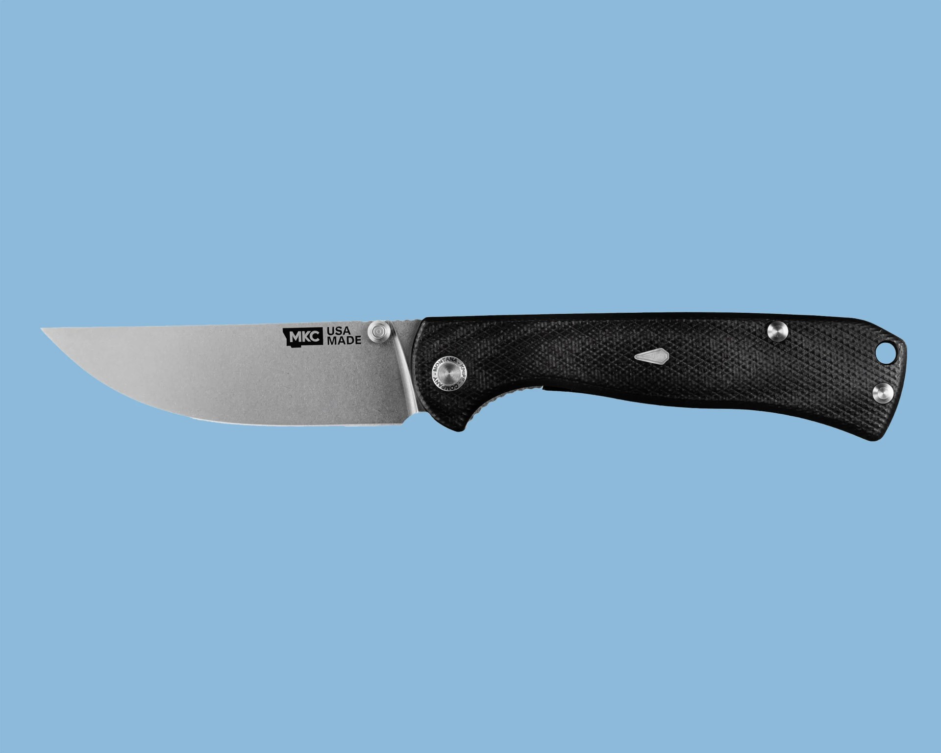 Folding knife with a stonewashed blade marked "MKC USA MADE" and a textured black handle.