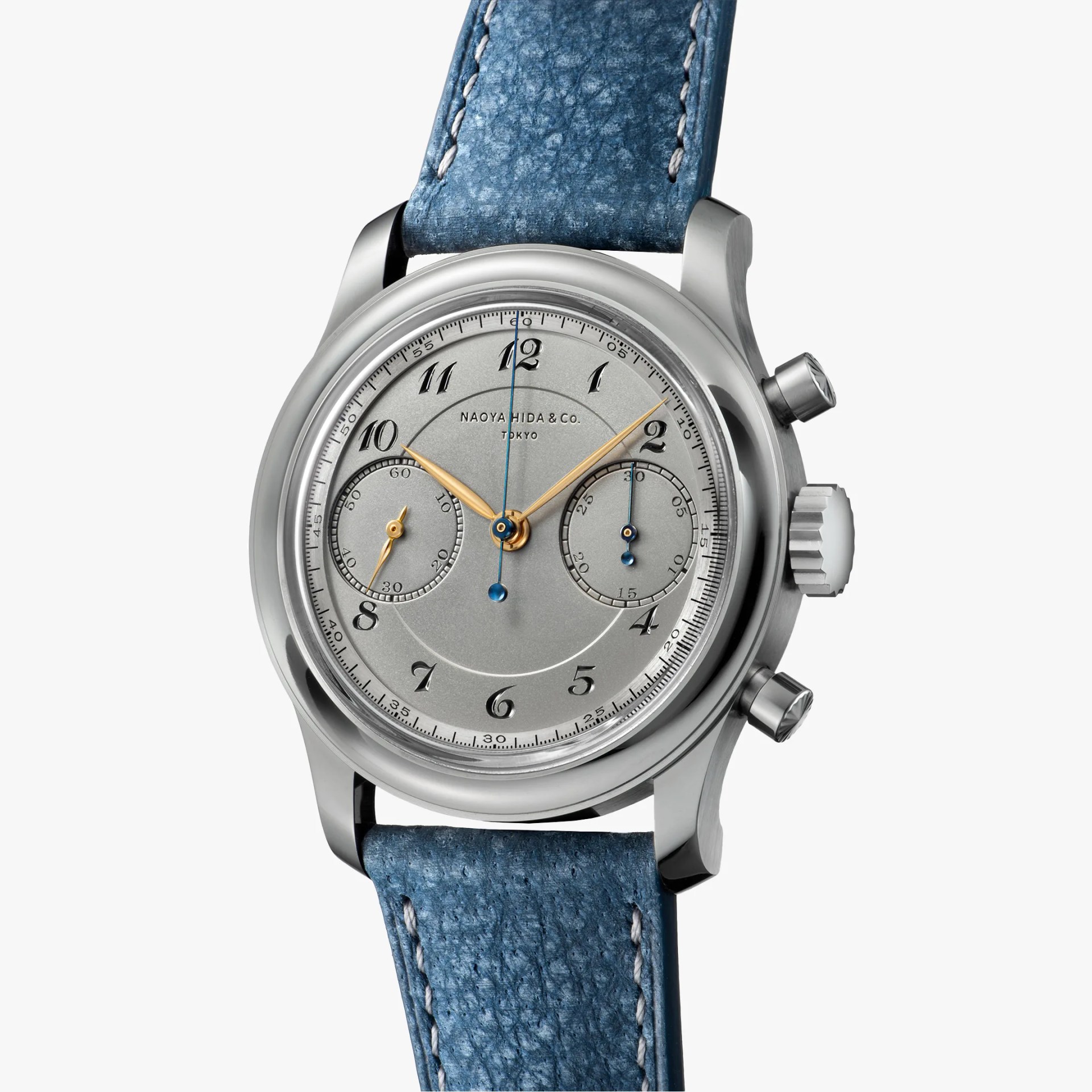 Silver chronograph wristwatch with gold hands, black numerals, and blue leather strap.