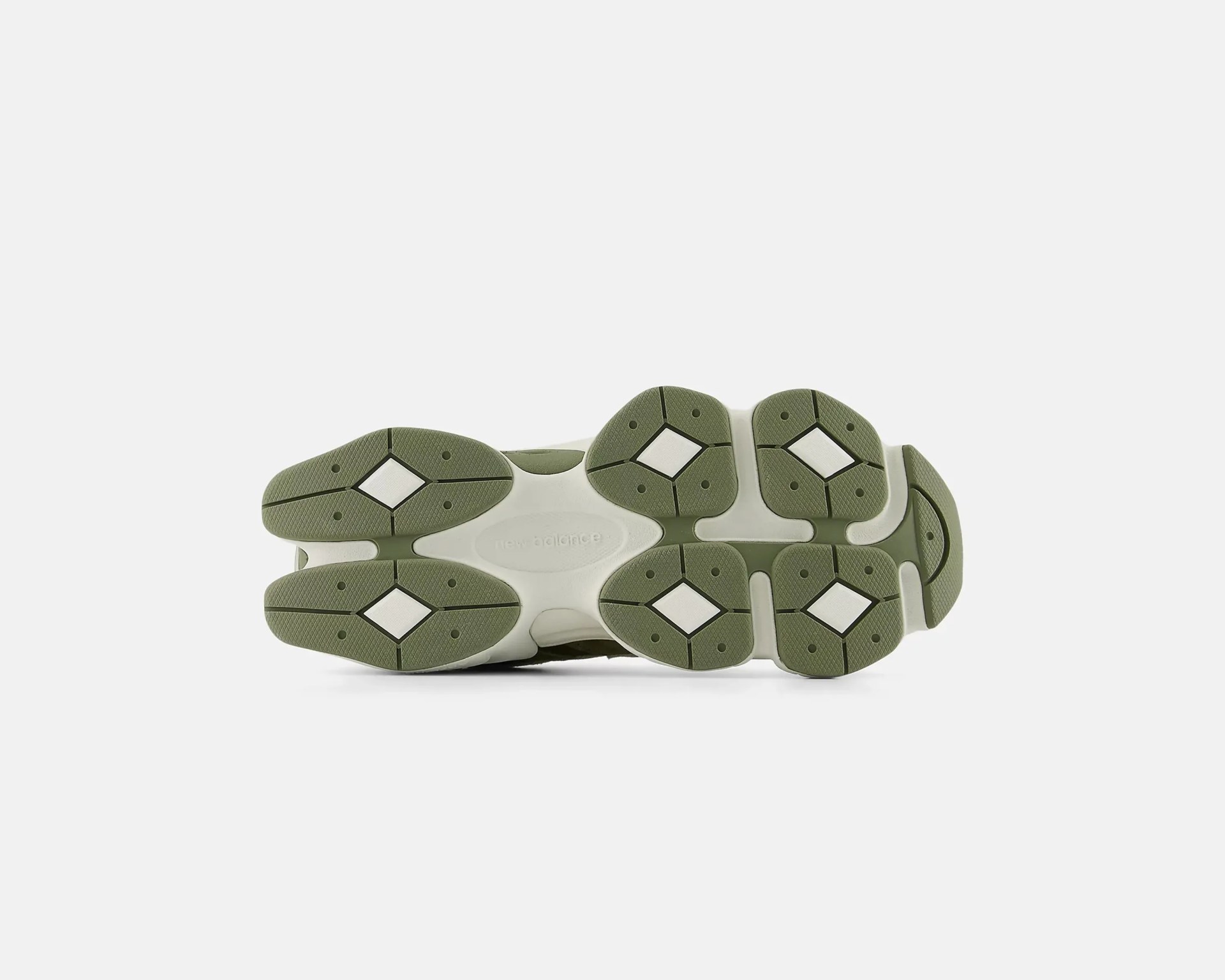 Sole of a New Balance shoe with olive green and white rubber tread pattern.