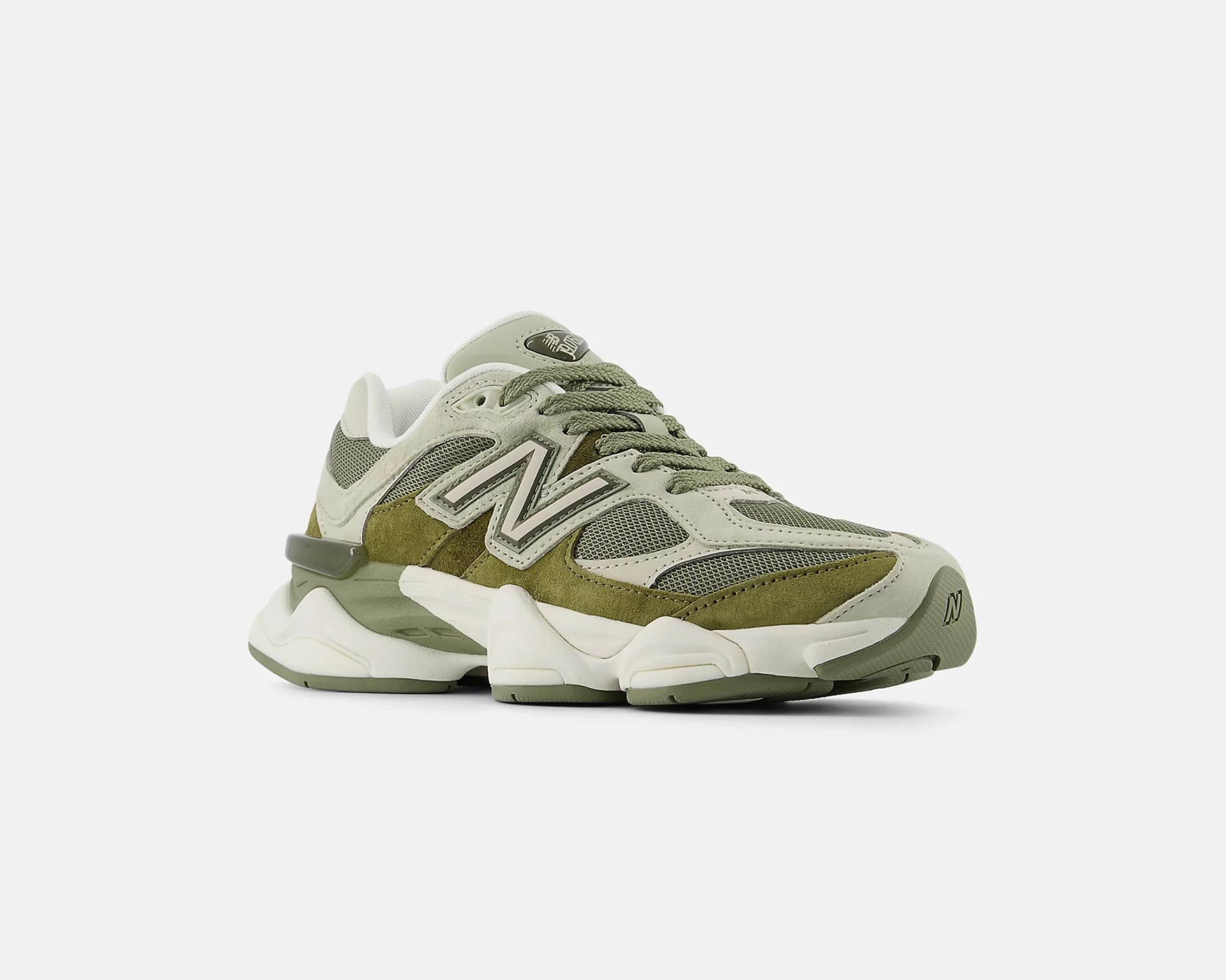 Chunky New Balance sneaker in olive green and beige with mesh and suede panels and thick white sole.