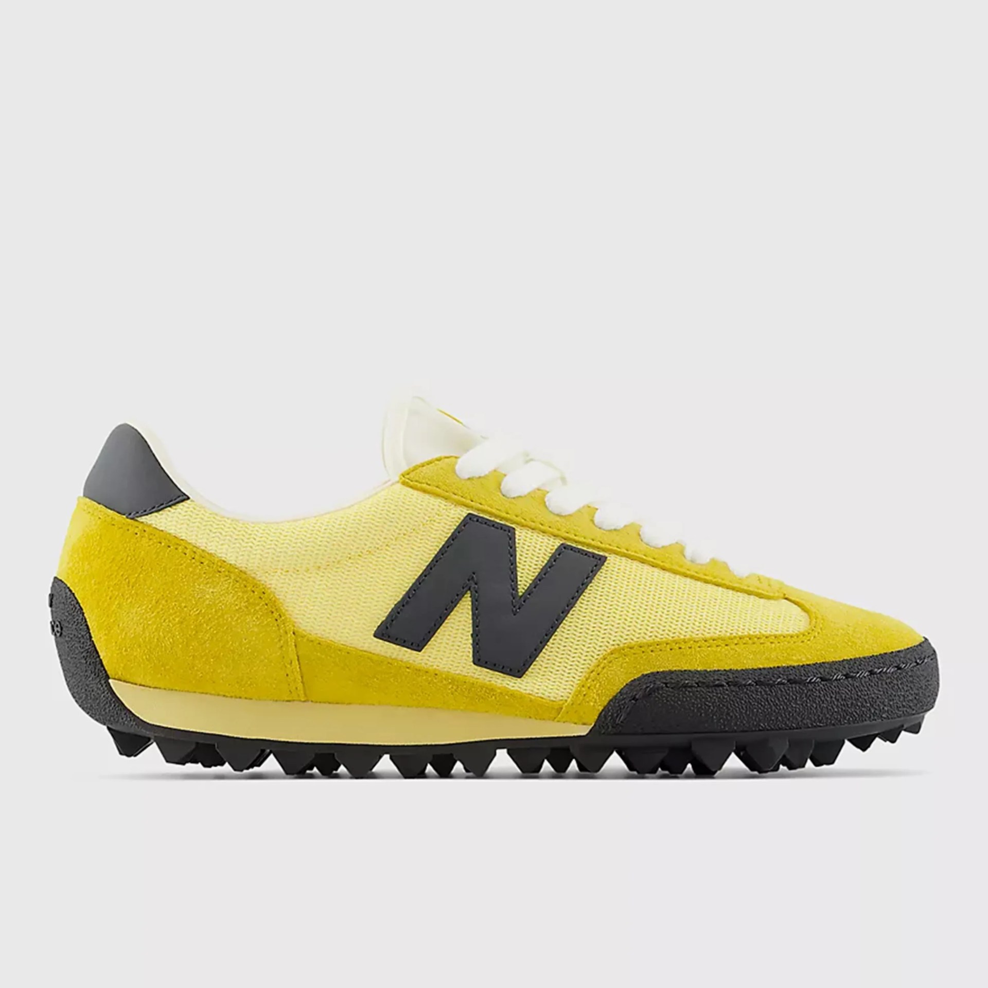 Yellow and black New Balance sneaker with white laces and a textured sole.