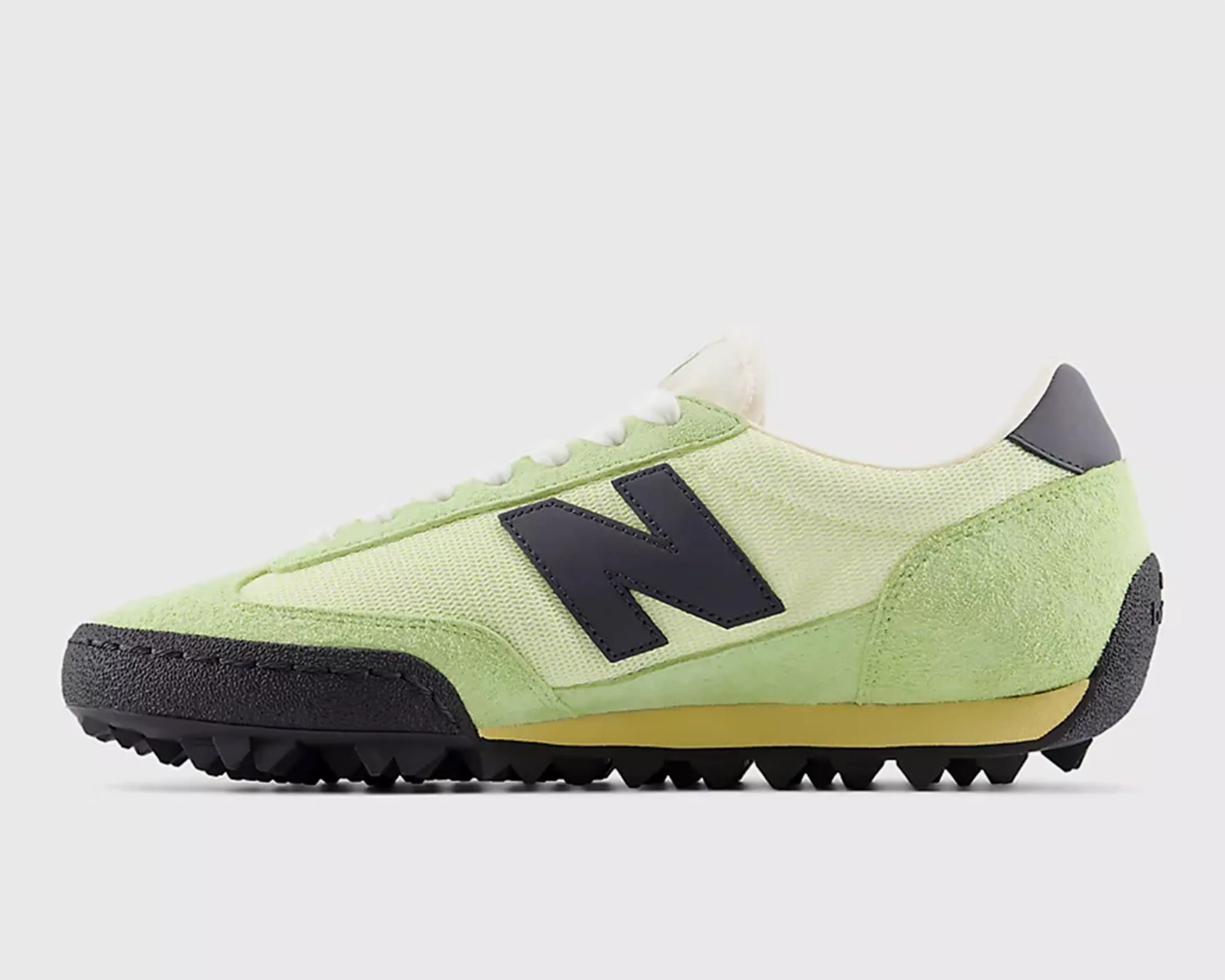 Light green New Balance sneaker with black "N" logo, black sole, and white laces on a white background.