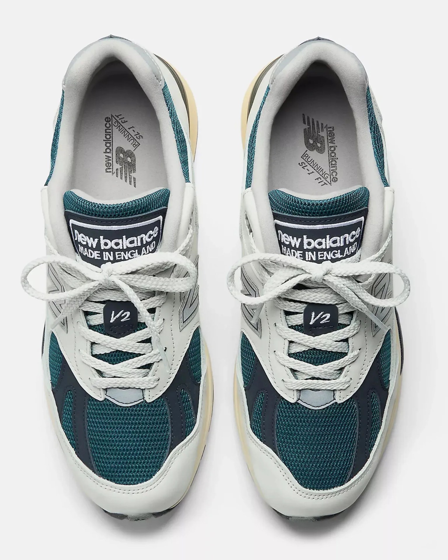 Pair of New Balance V2 running shoes in teal mesh and white leather with white laces, viewed from above.