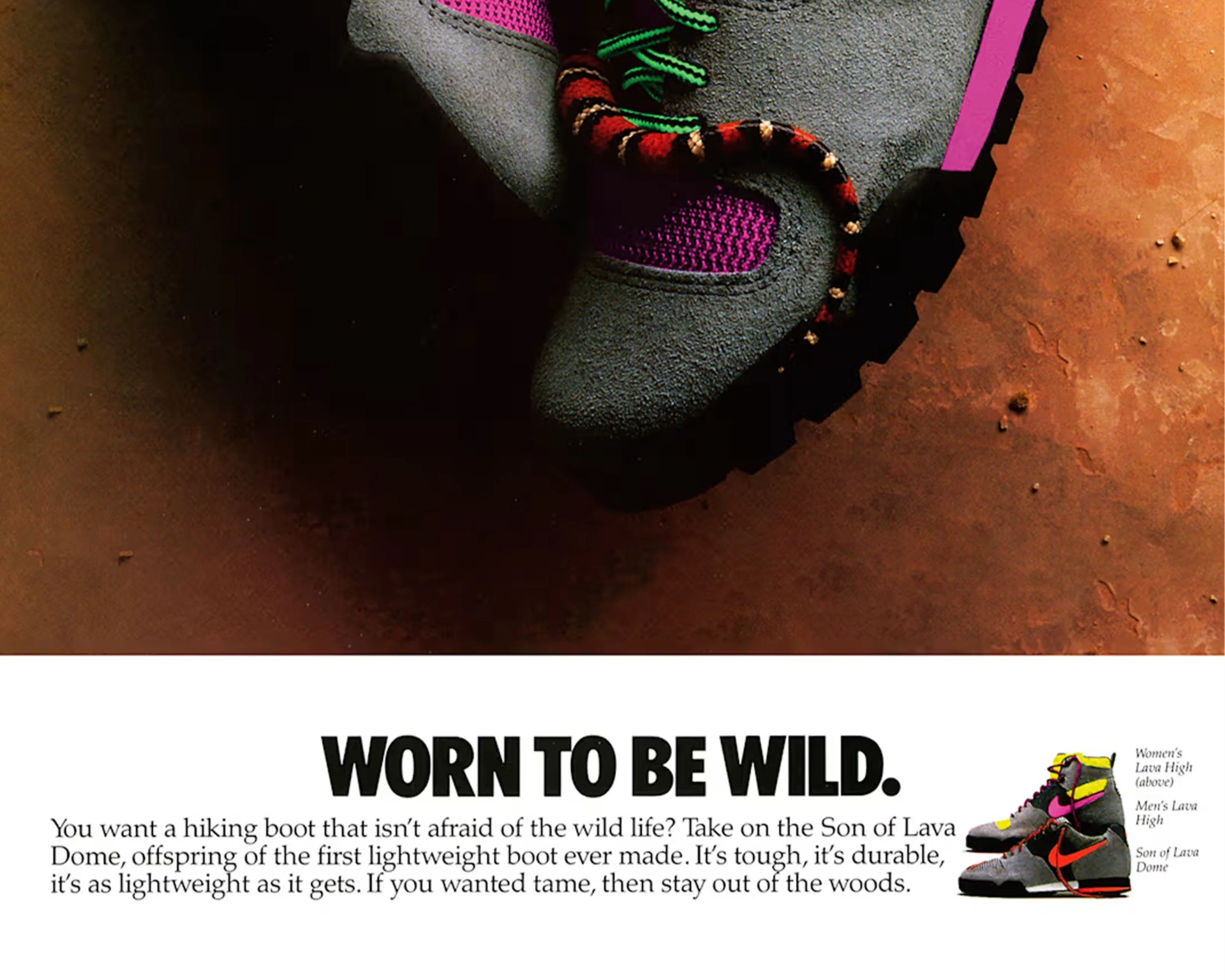 Gray and pink hiking boot with green laces and a small red and black snake on a brown surface.