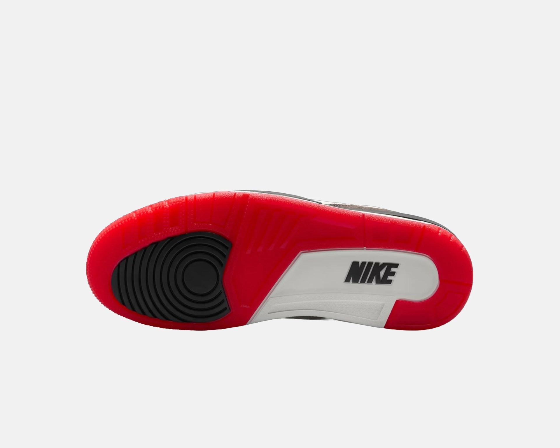 Red, black, and white Nike sneaker sole with circular tread pattern and Nike logo.