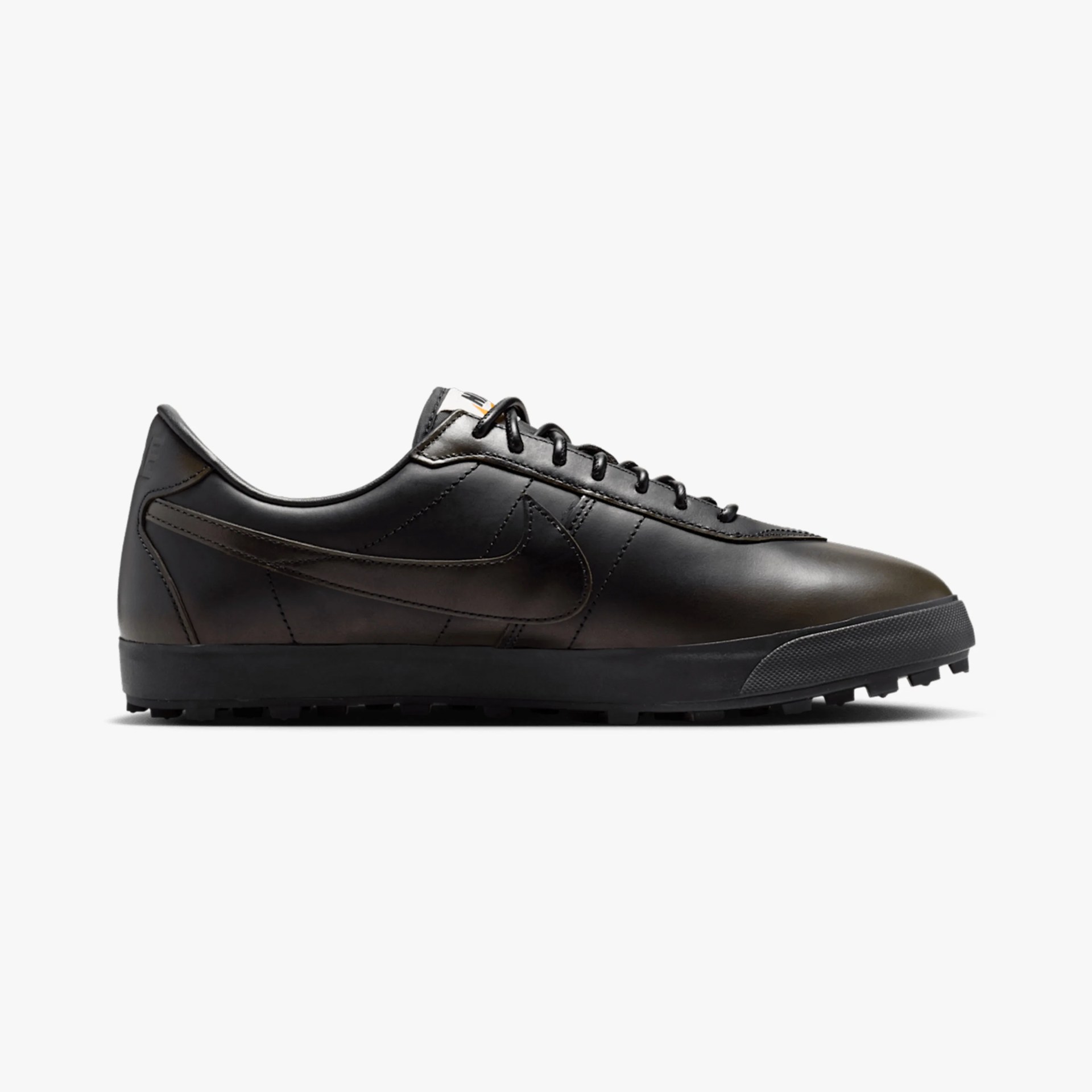 Black leather Nike sneaker with black laces and textured black sole.