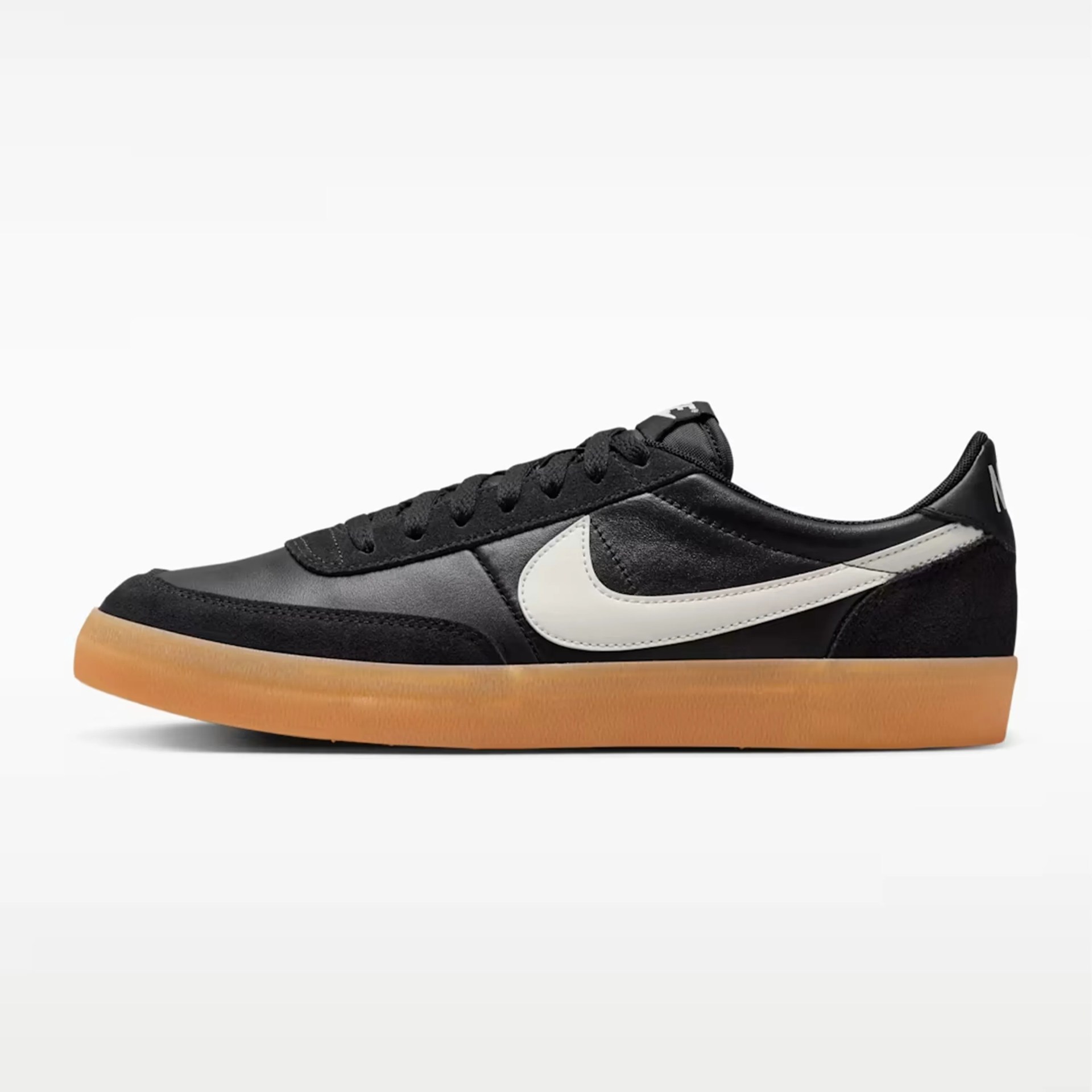 Black Nike sneaker with white swoosh logo and gum sole viewed from the side.