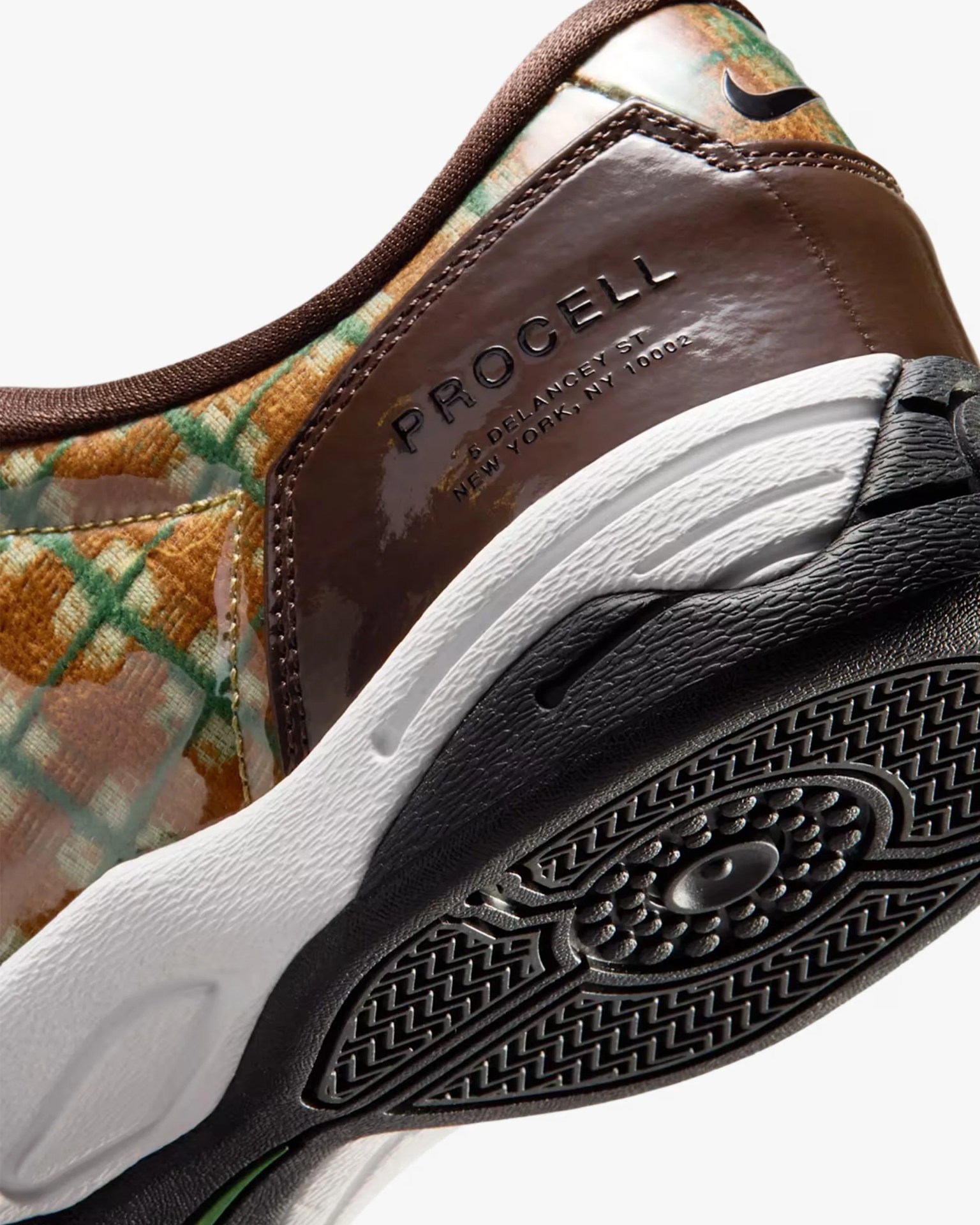 Close-up of a brown and multicolor Nike Procell sneaker heel with white midsole and black outsole tread.